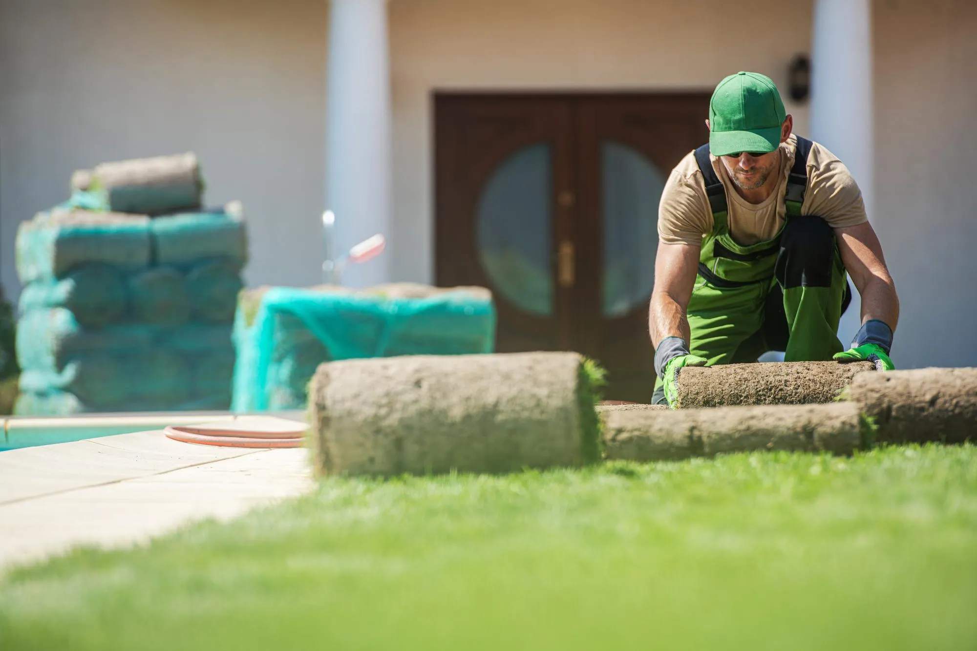 Ground Preparation and Sod Installation in Residential Backyard Garden