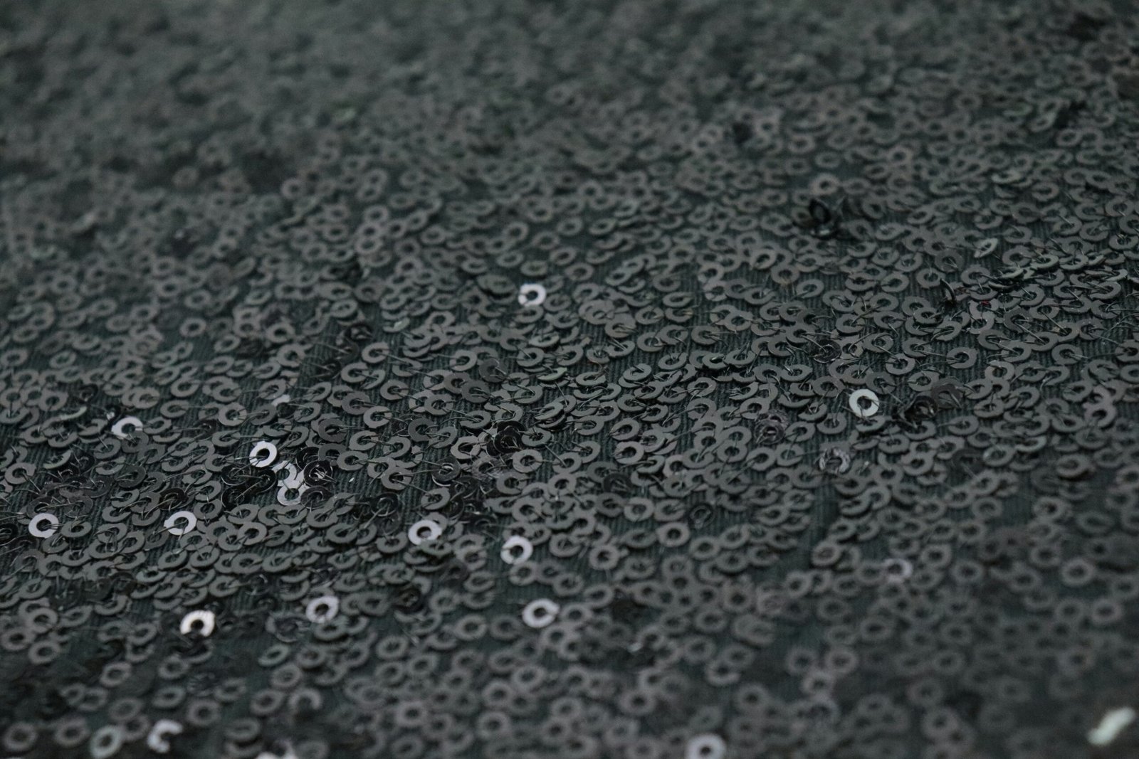 a close up of water droplets on a black surface