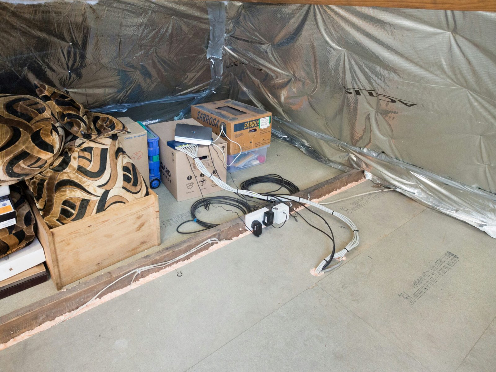 Cluttered basement space with various items and boxes.