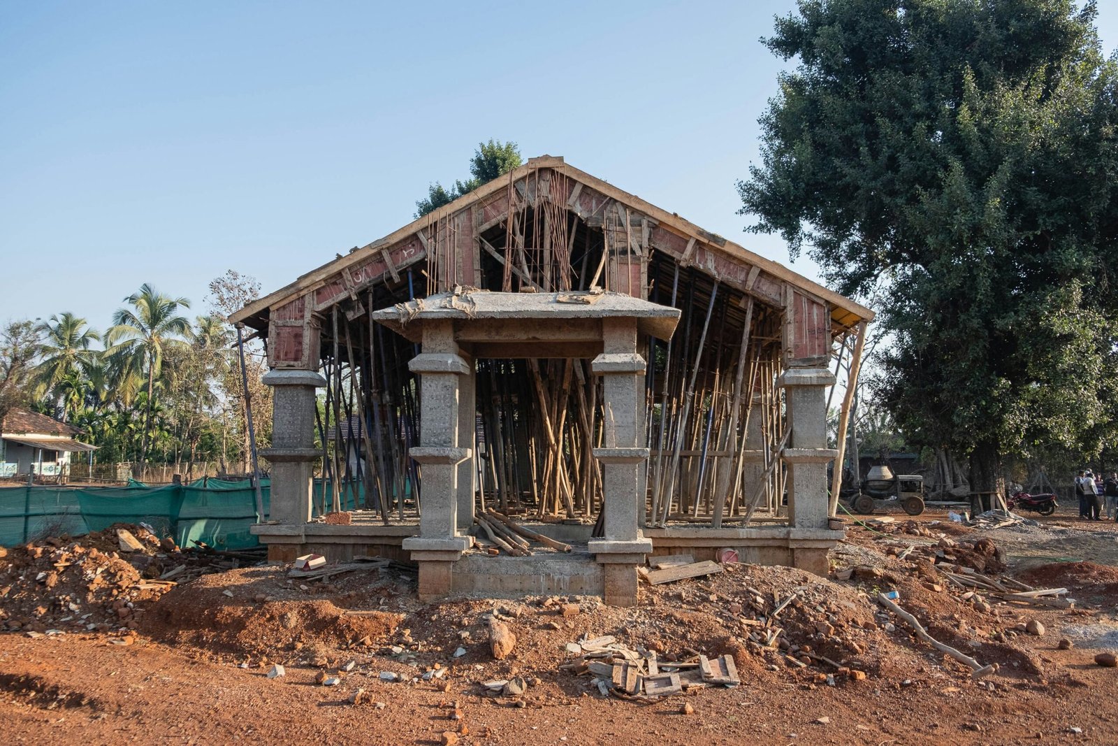 a wooden structure sitting on top of a dirt field