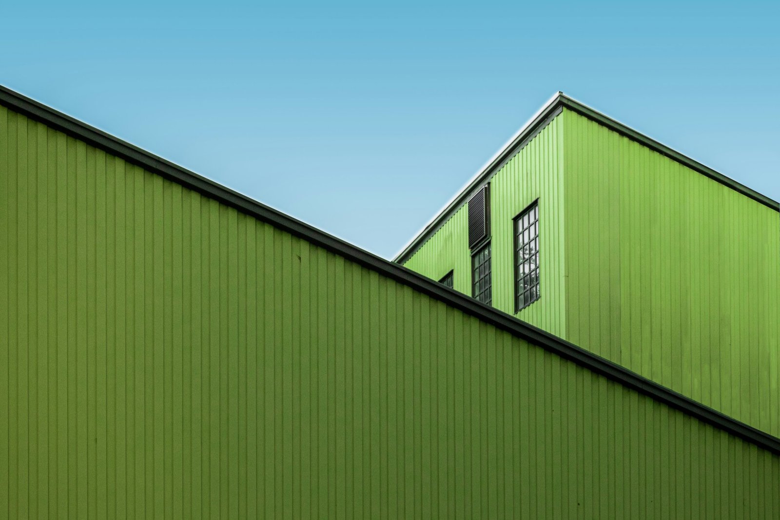 green and white wooden house under blue sky during daytime