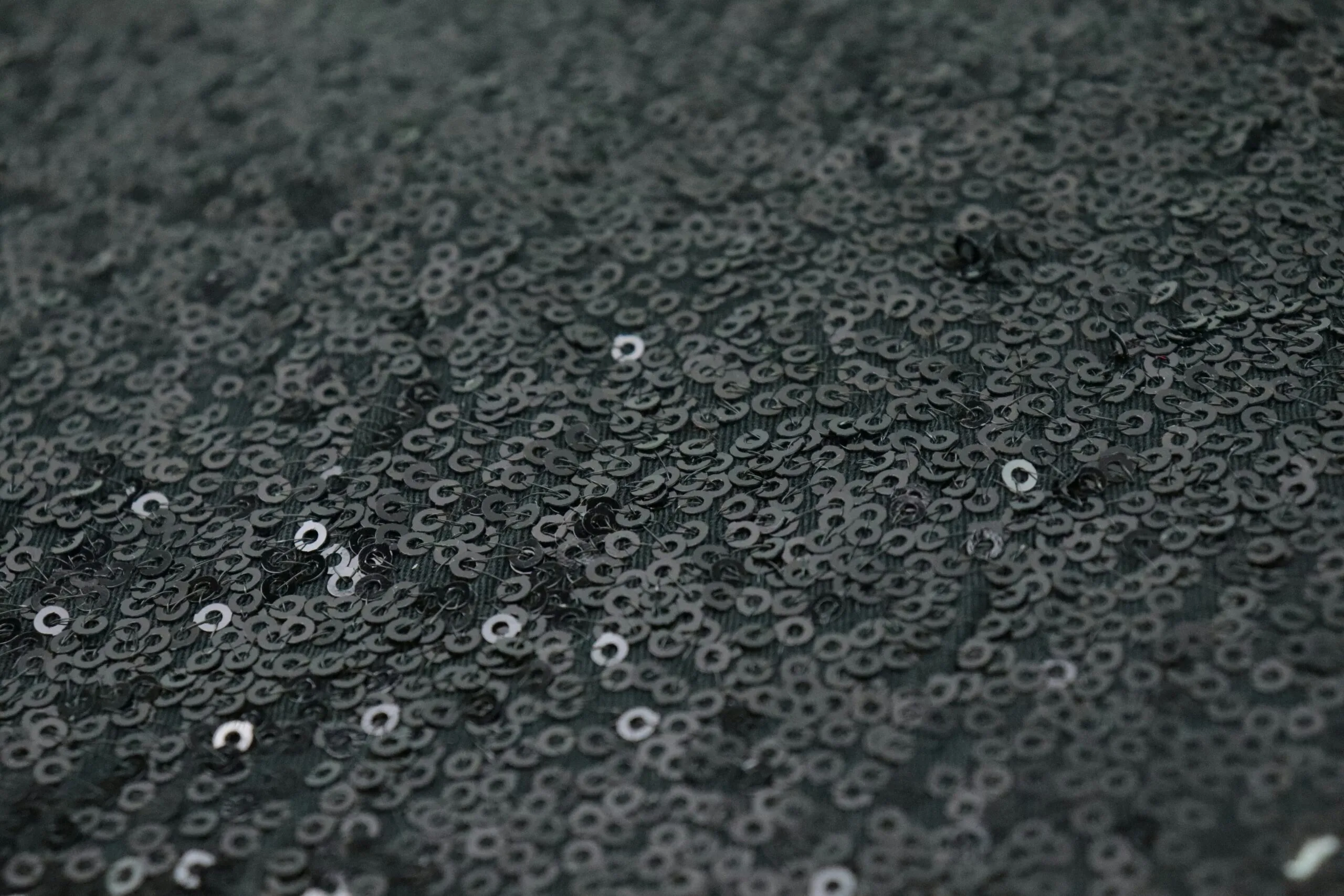 a close up of water droplets on a black surface