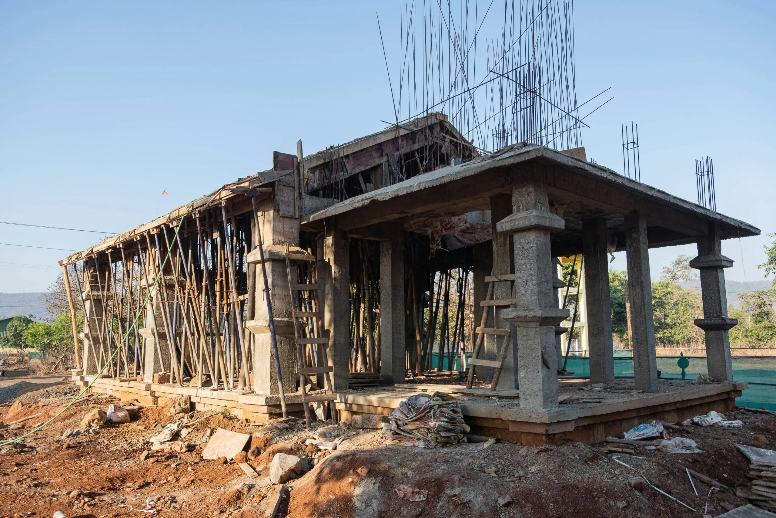 a wooden structure sitting on top of a dirt field