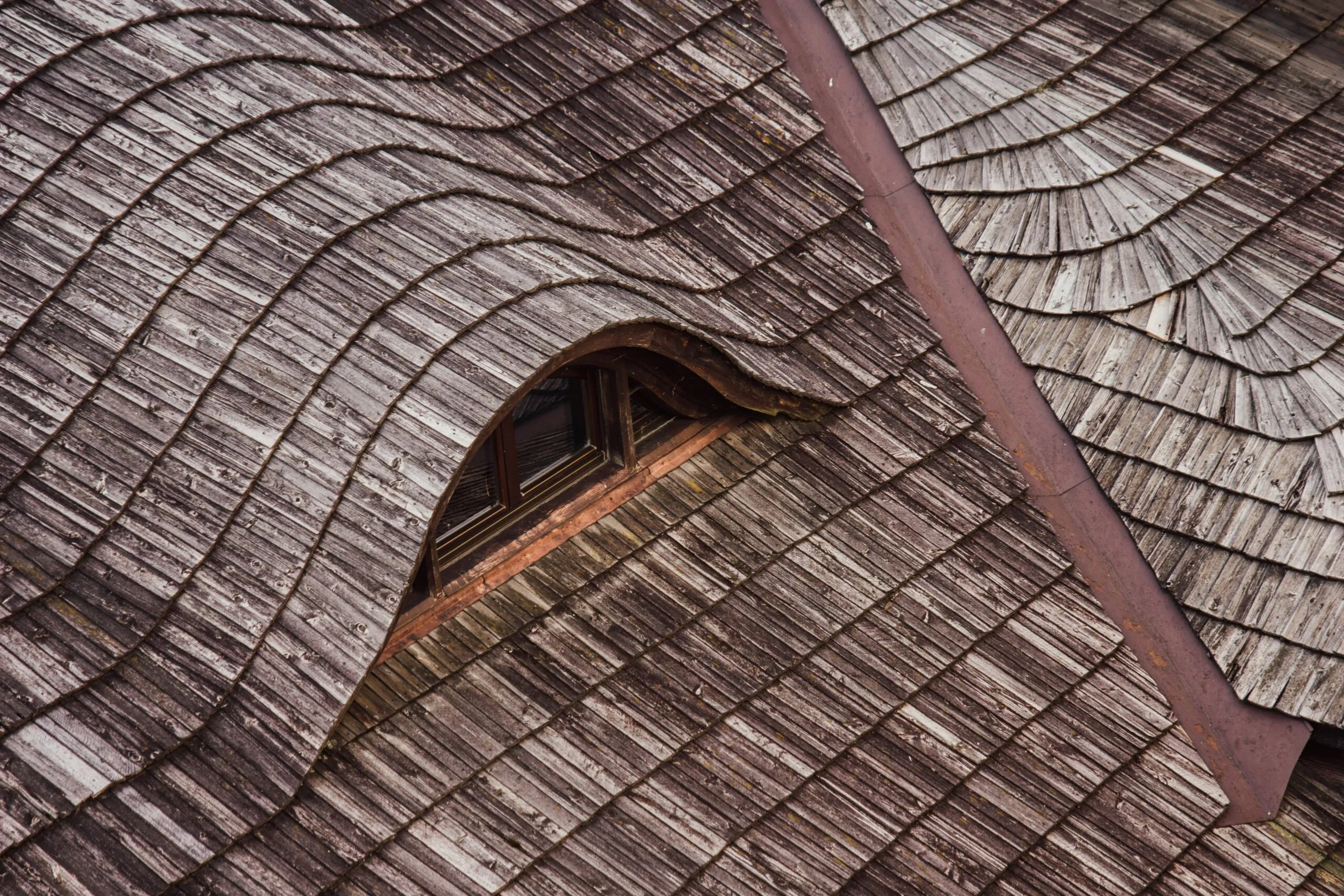 a close up of a wooden roof with a window