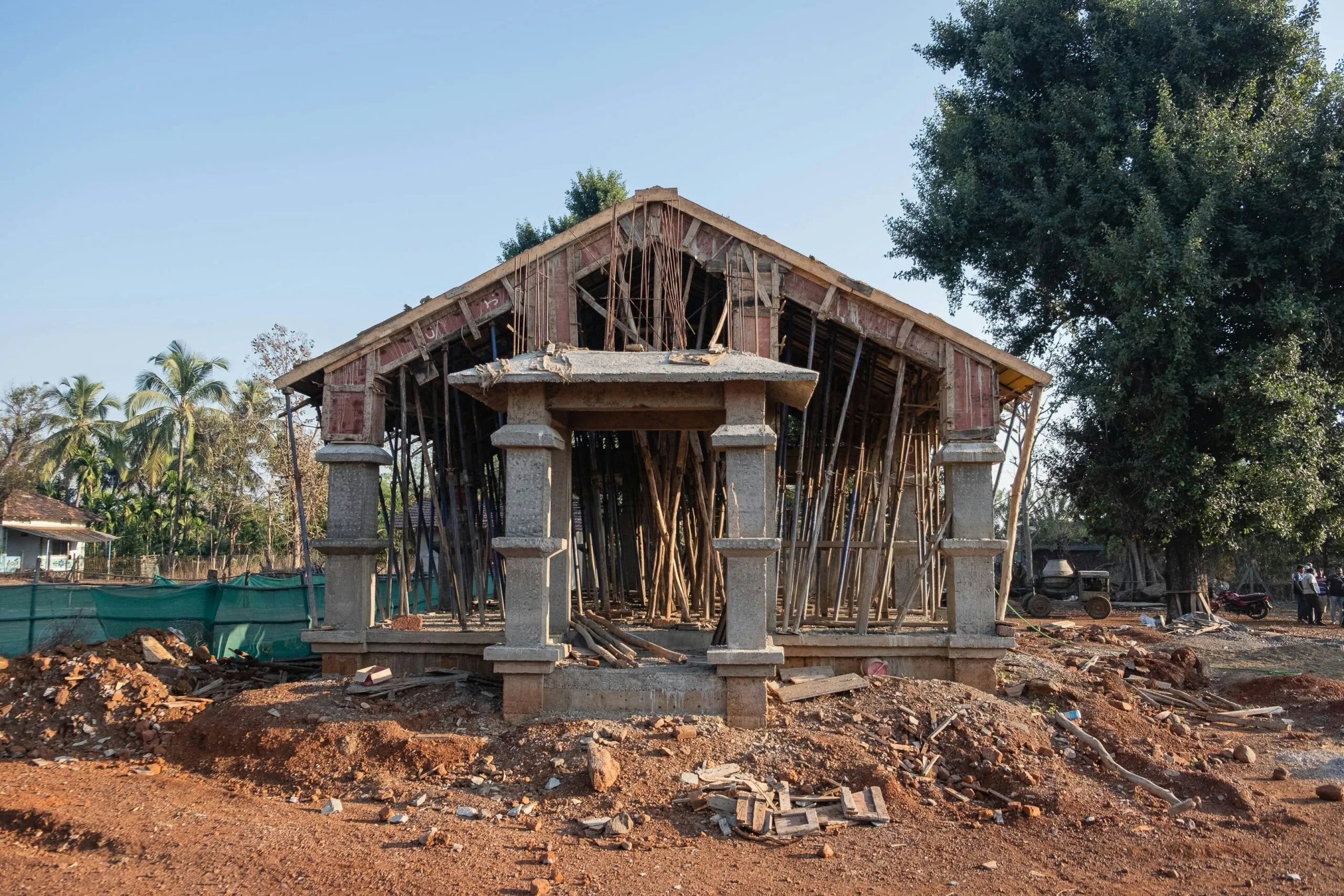 a wooden structure sitting on top of a dirt field
