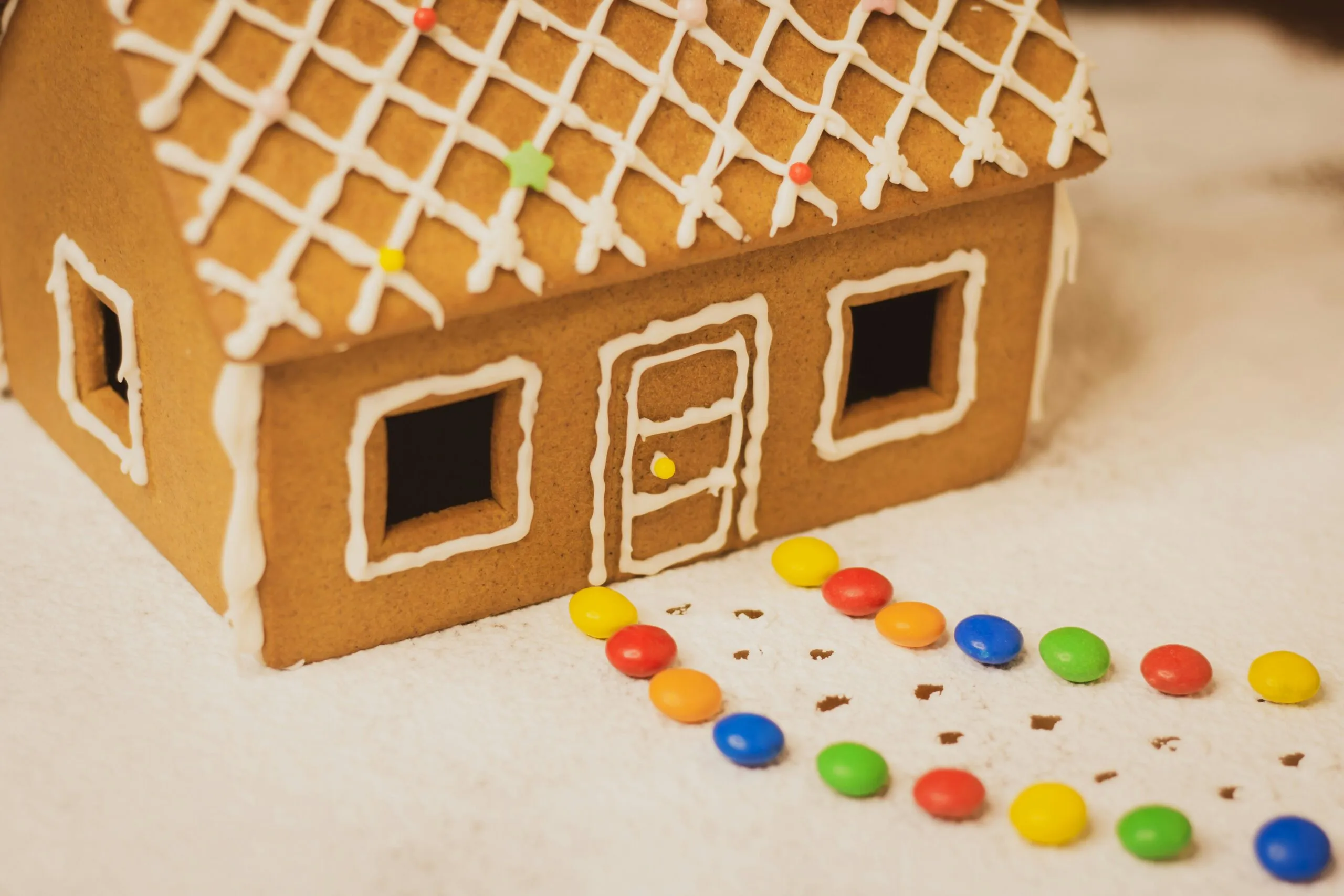 a gingerbread house with a lot of candy on the floor