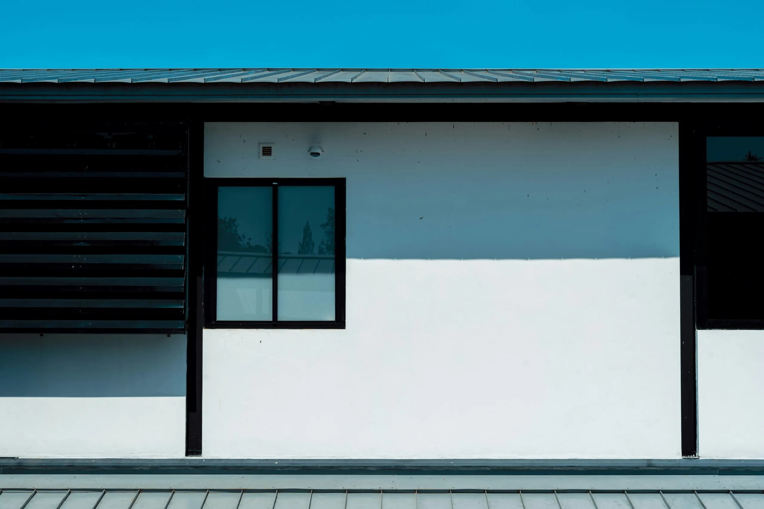a black and white building with a clock on the side of it