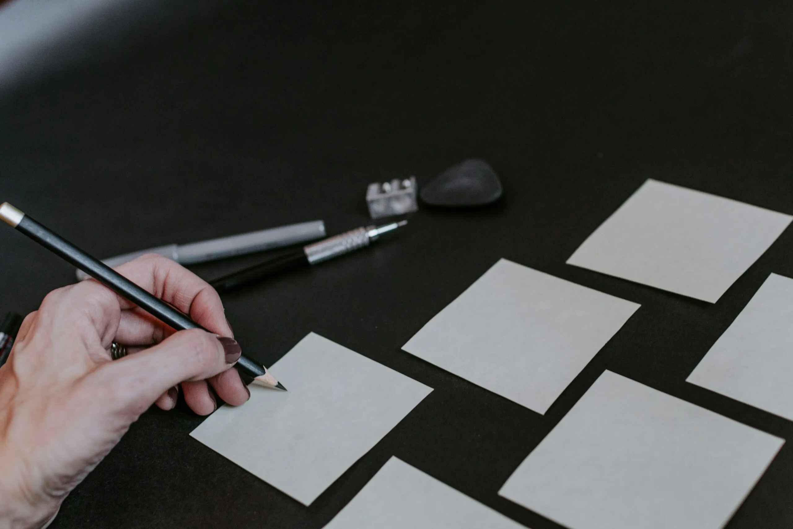 A person is drawing squares on a table