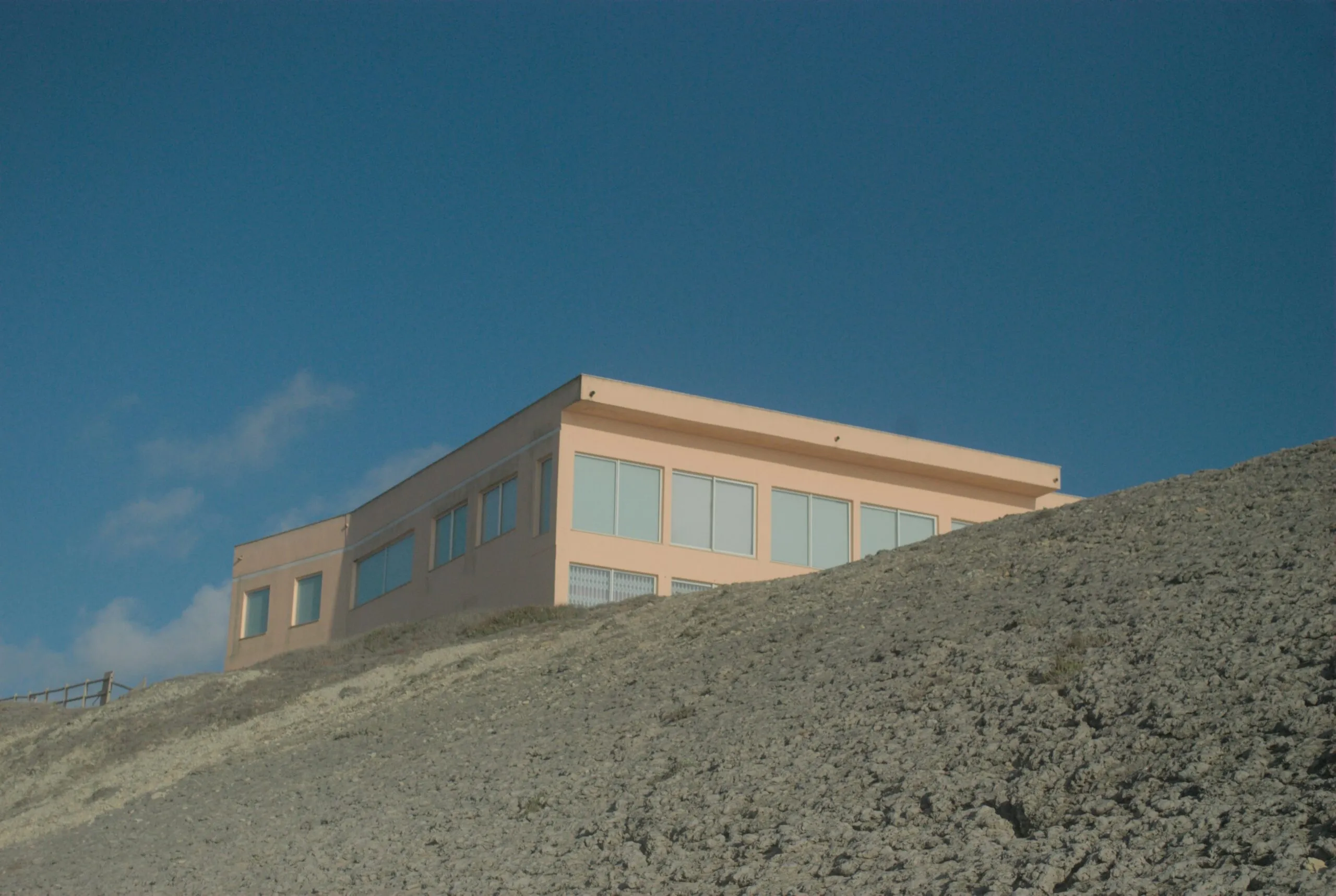 A building on top of a hill with a sky background