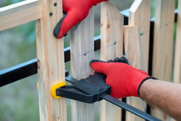 Woodworking sash clamp used to hold planks in place making new fence
