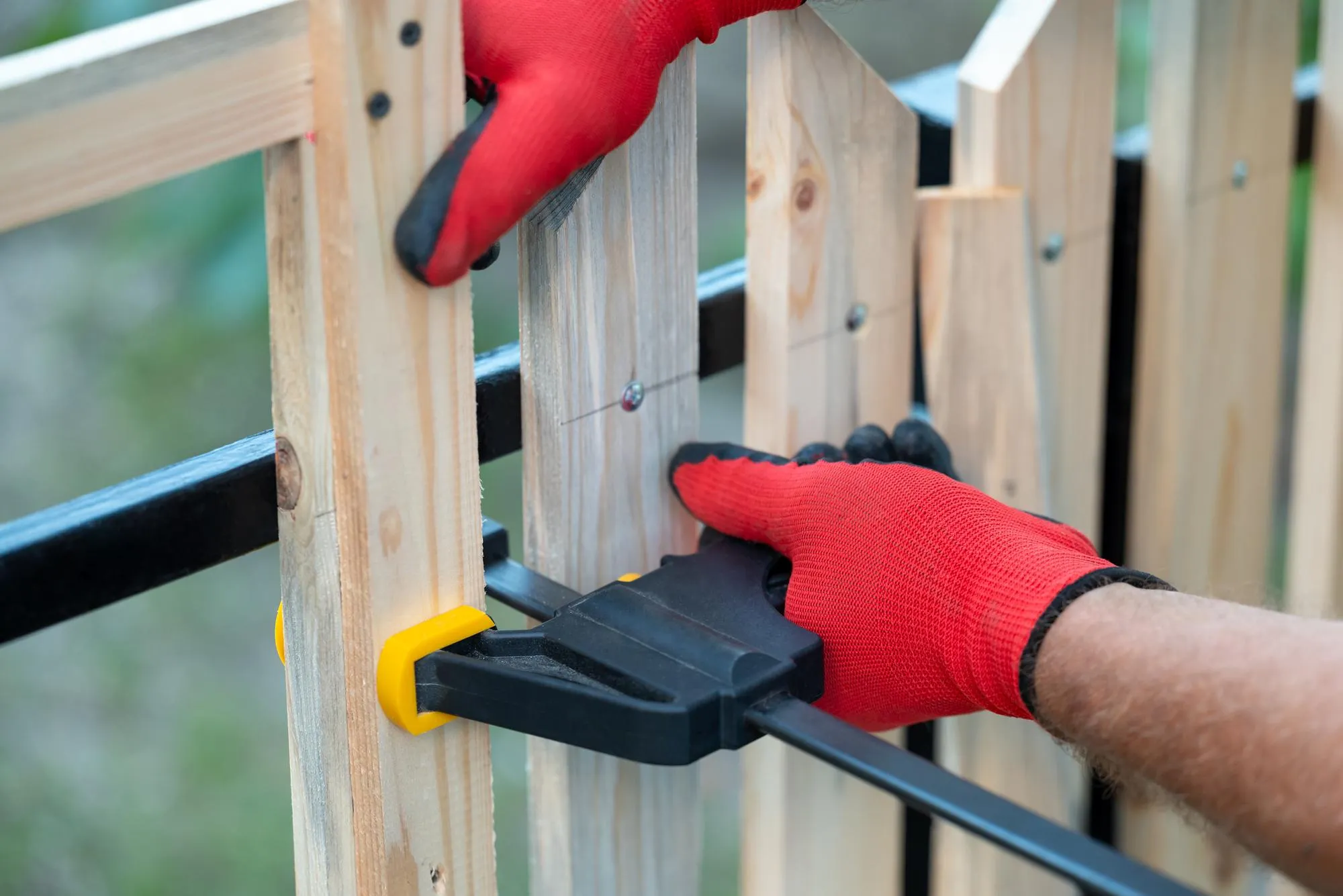 Woodworking sash clamp used to hold planks in place making new fence