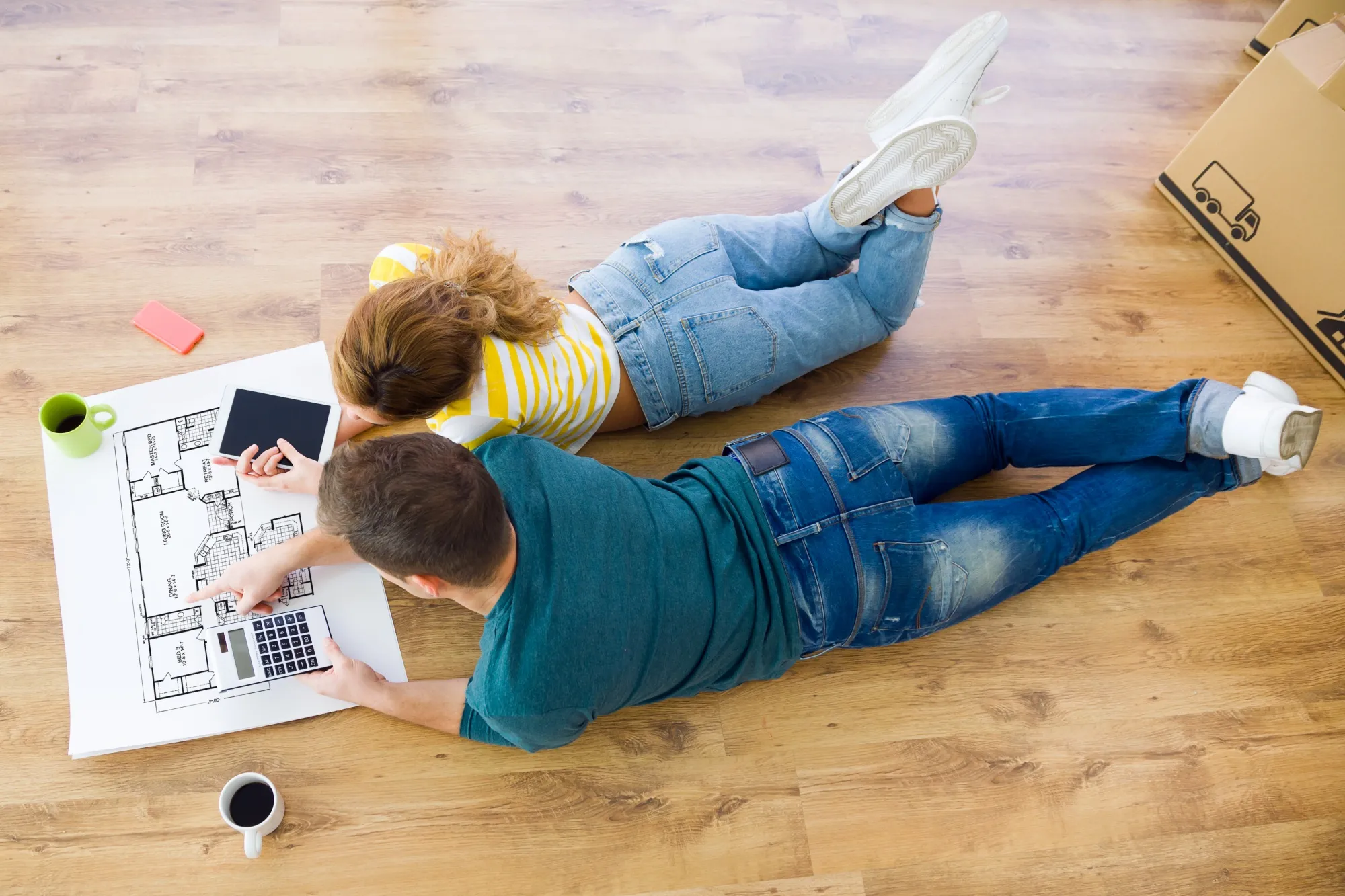 Young couple with digital tablet in their new home