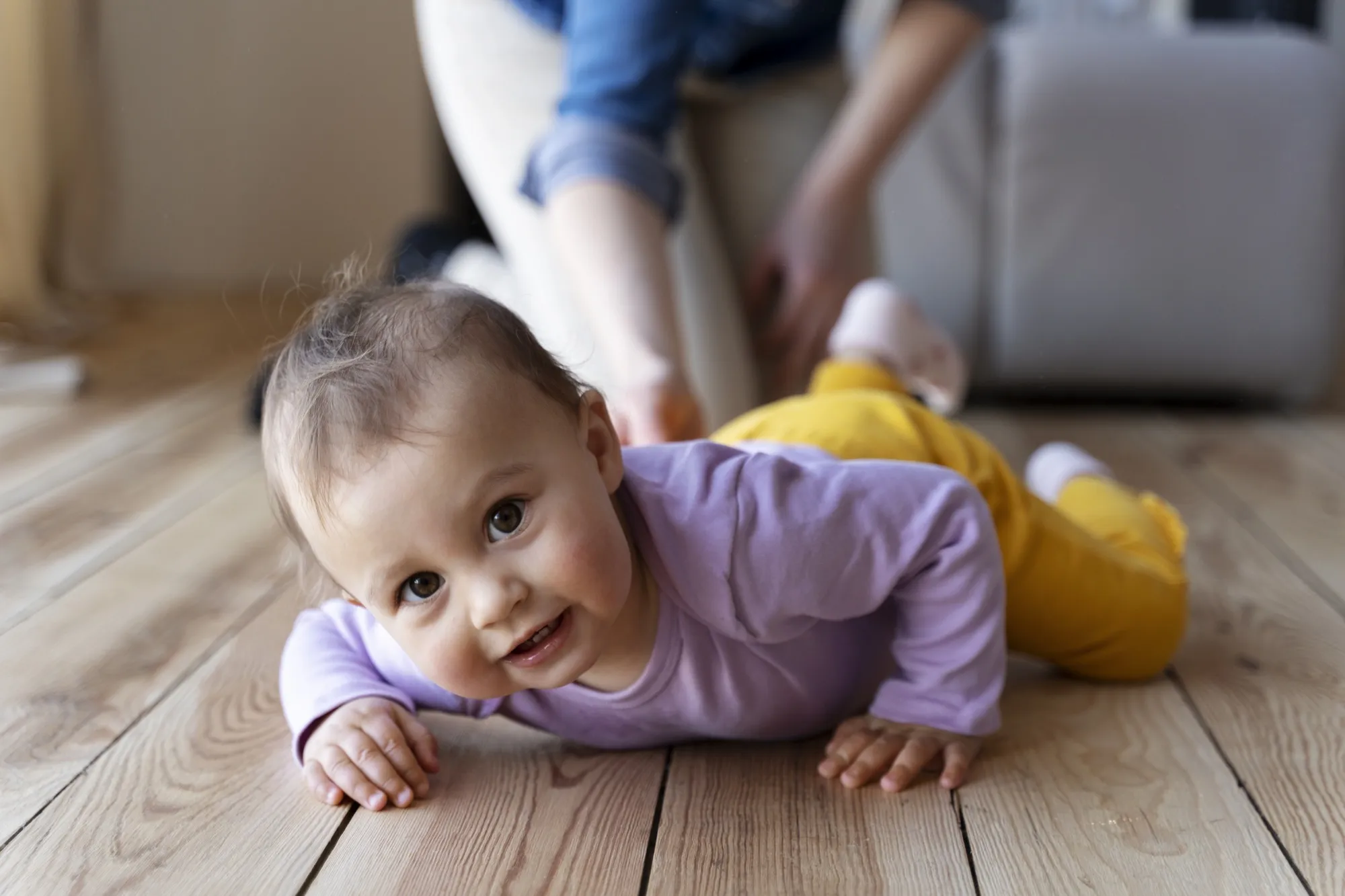 Baby crawling with his mother's help