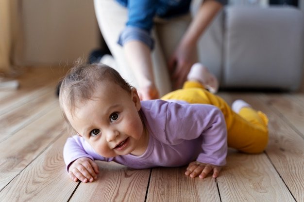 Baby crawling with his mother's help