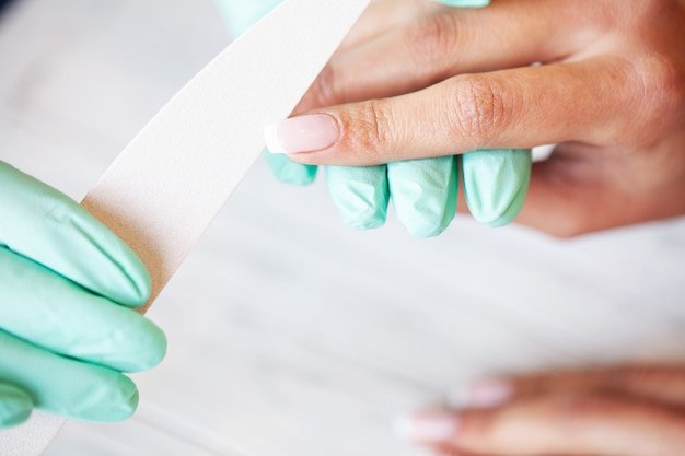Beauty . Young woman doing manicure in salon