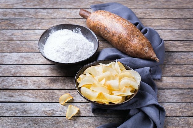 Brazilian cuisine food latin snack Yucca yuca cassava manioca chips and flour on a table