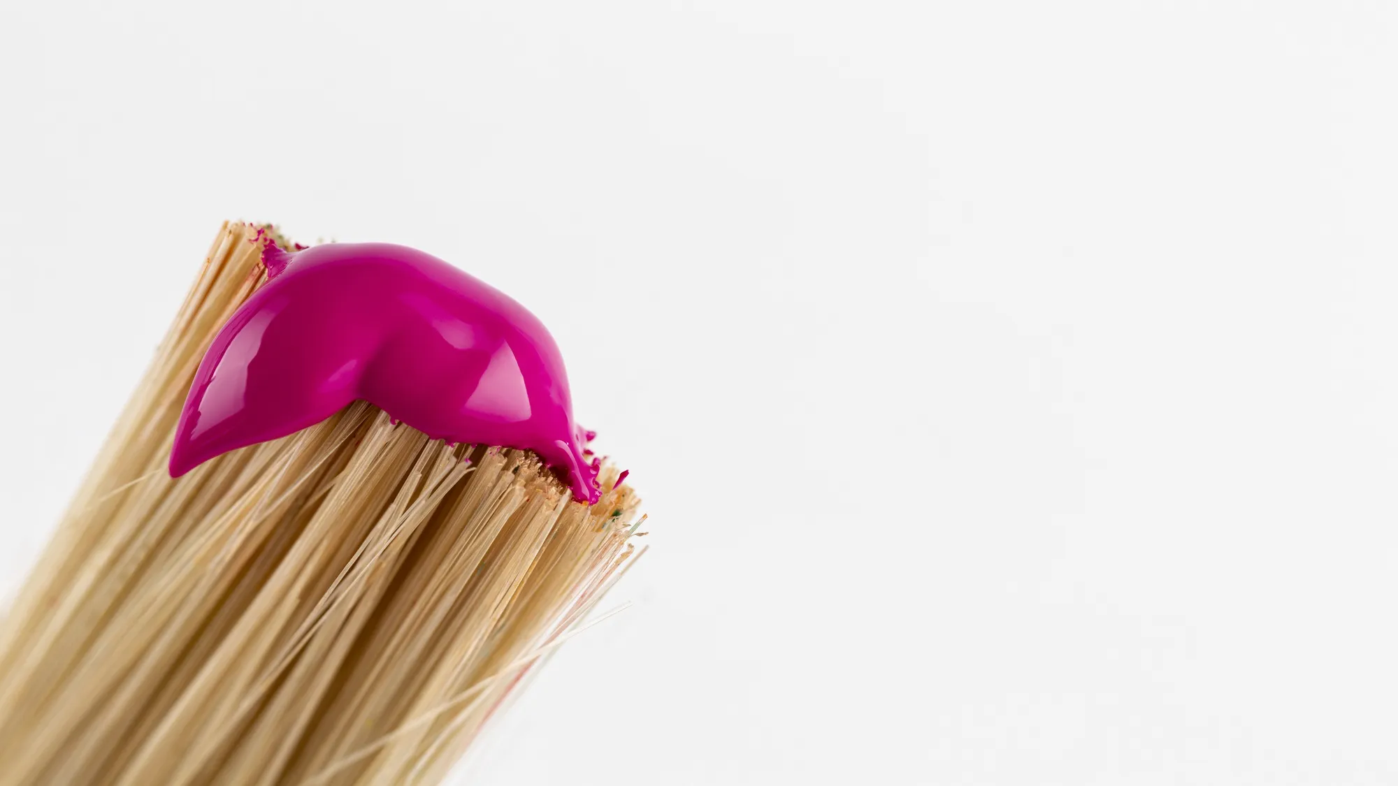 Brush with pink paint and copy space