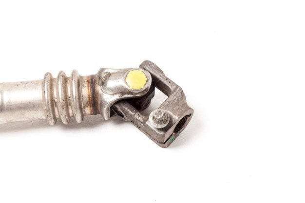 The car's spare part is a metal cardan shaft on a white background with inscriptions identifying the model Repair of equipment during autoanalysis in the workshop