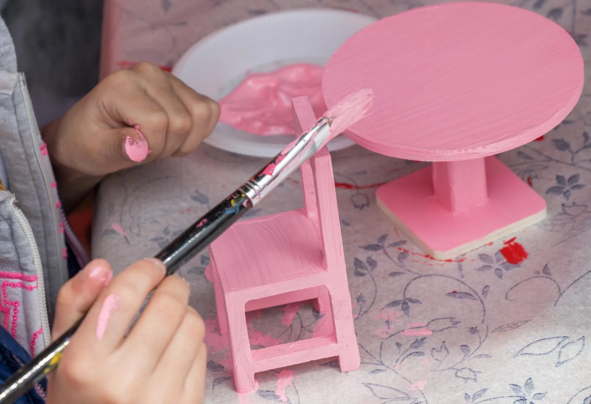 Children decorating handmade wooden table