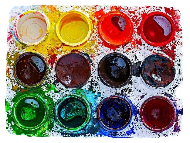 Close-up of colorful watercolor paints over white background