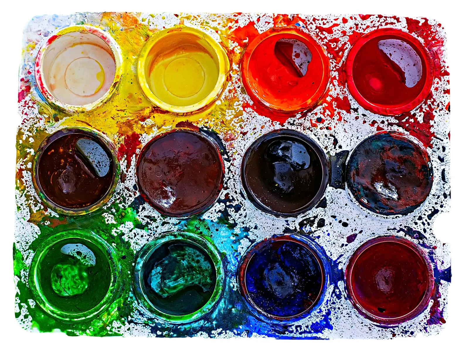 Close-up of colorful watercolor paints over white background