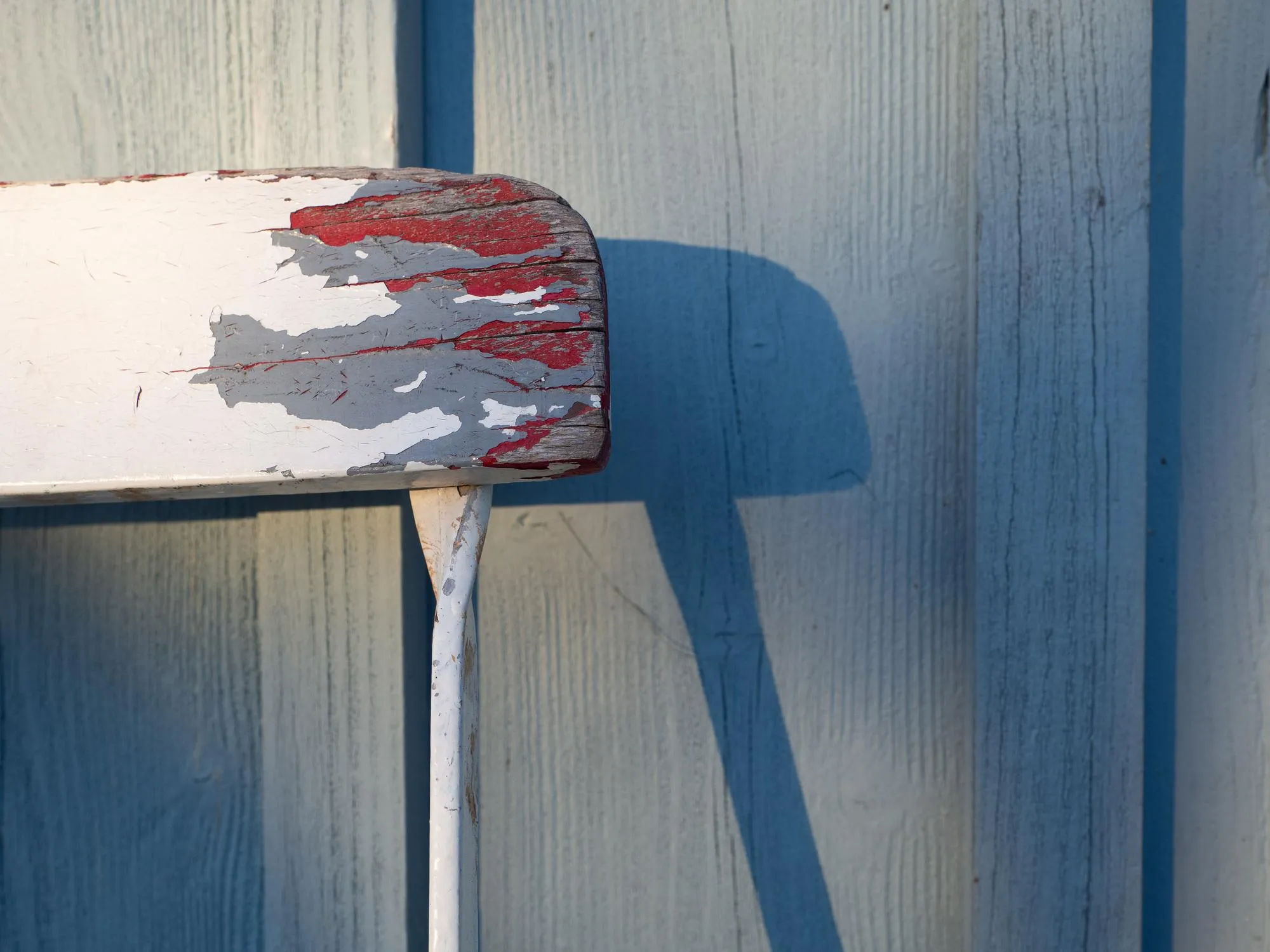 Close-up of flag against blue wall