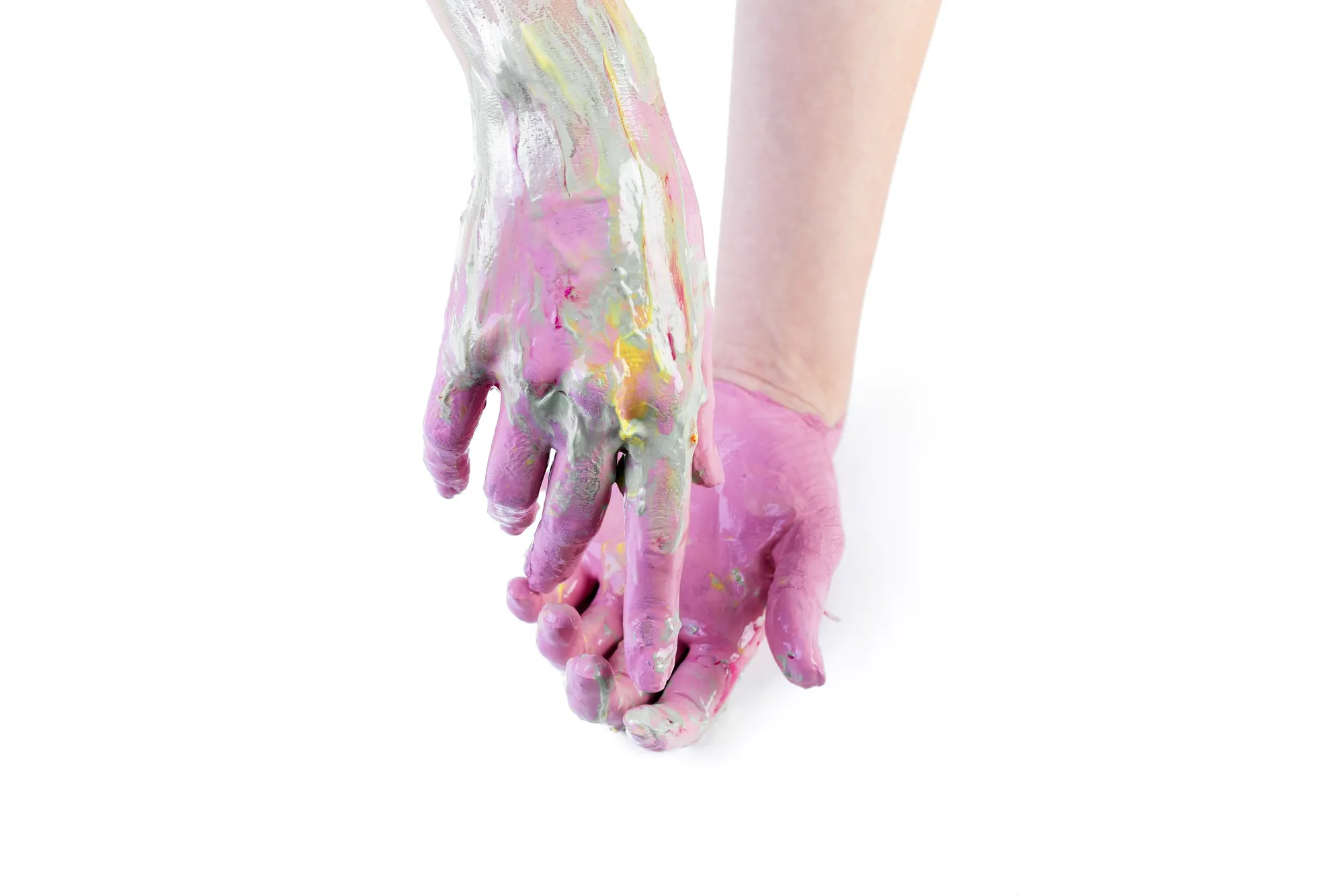 Close-up of a person's painted hands over white backdrop
