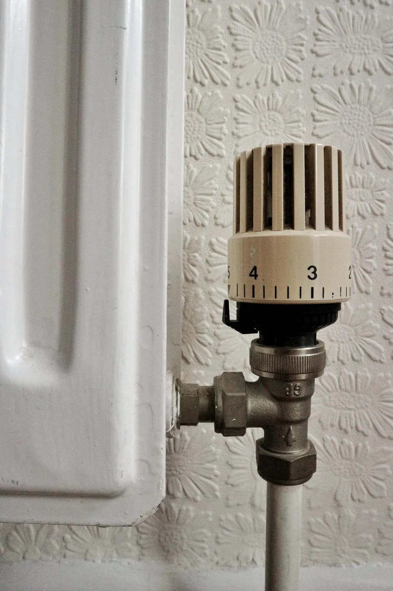 Close-up of thermostat by radiator