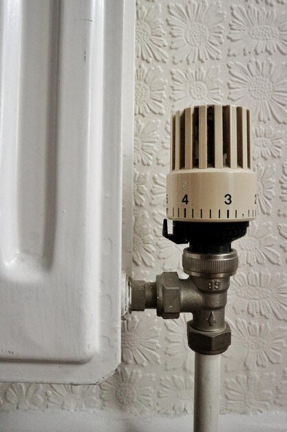 Close-up of thermostat by radiator