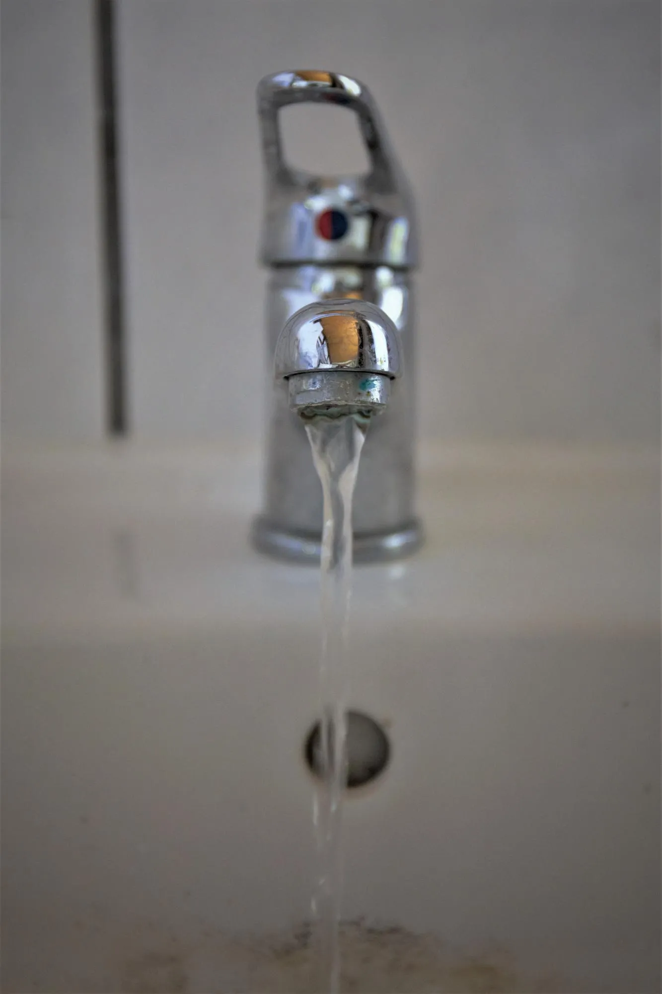 Close-up of water falling from faucet in bathroom