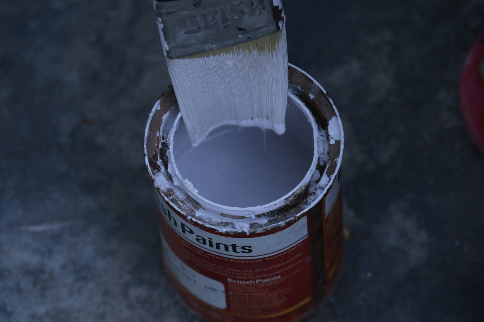 a paint can with a brush inside of it