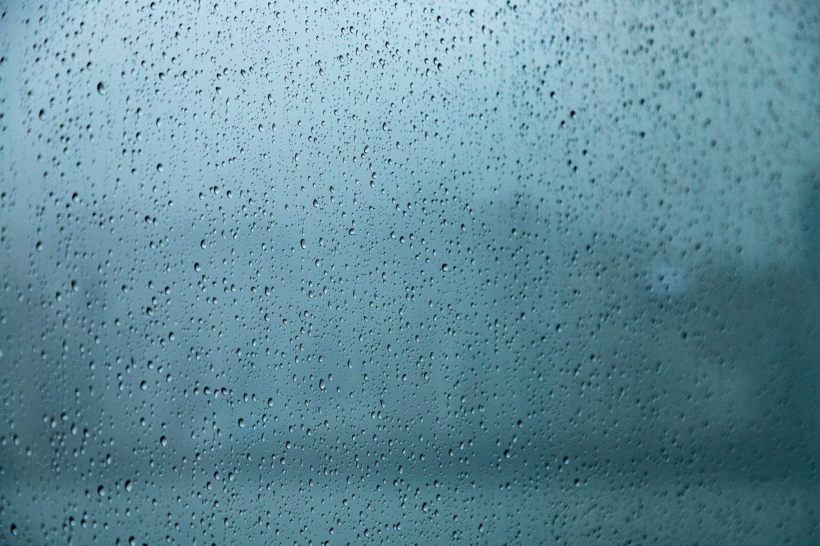 A close up of a window with rain drops