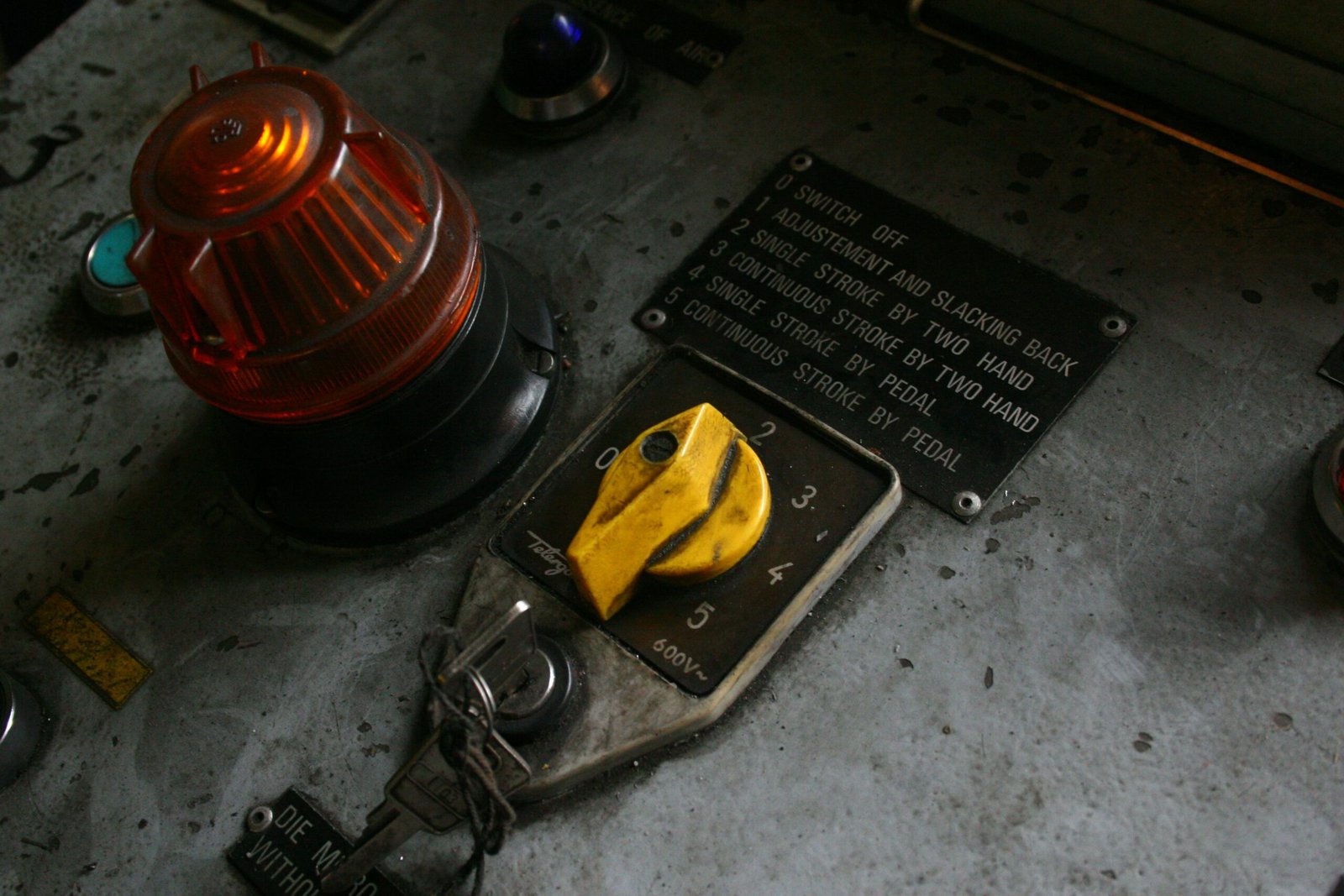 Close-up of a yellow toggle switch on a control panel.