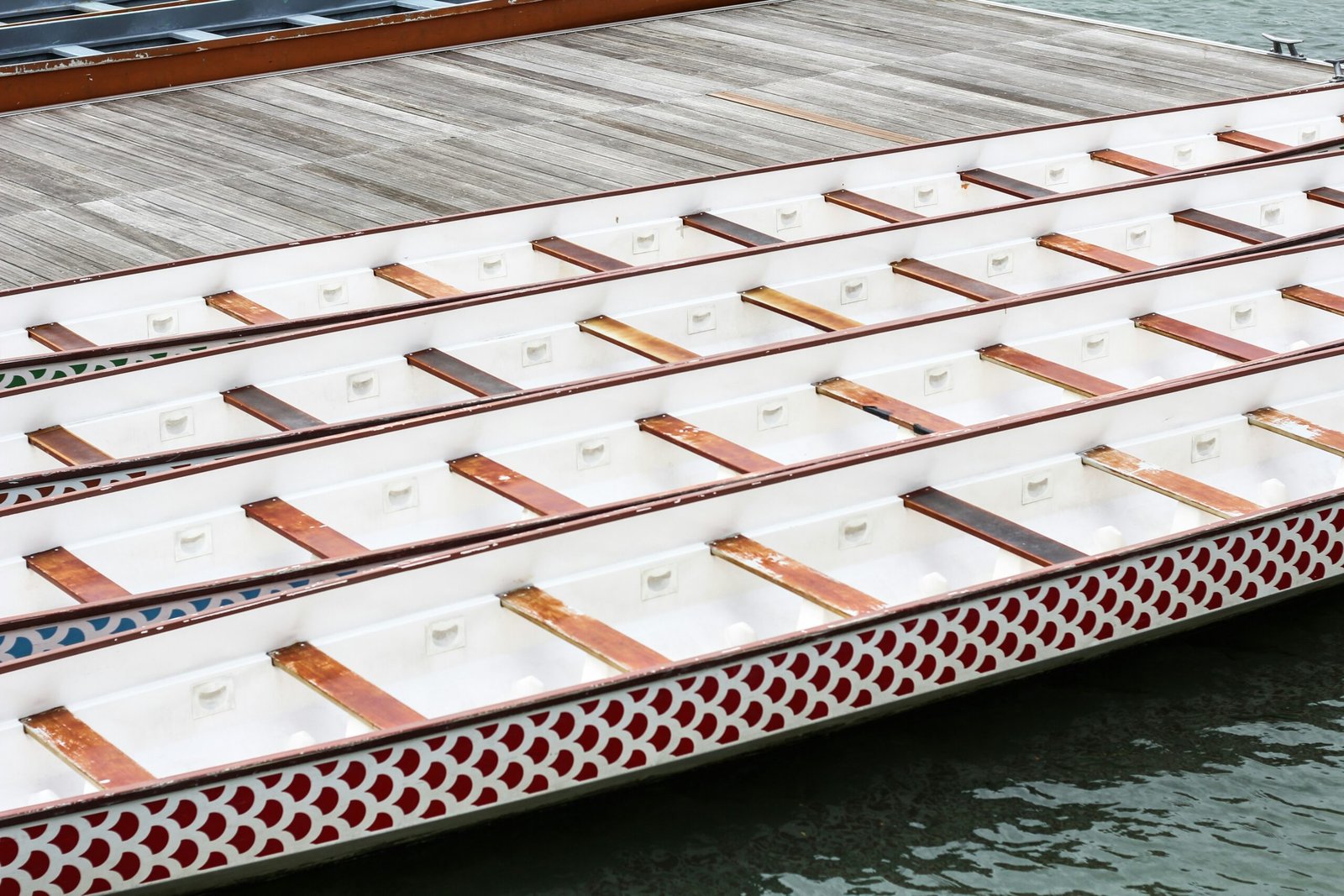 white-and-black wooden boats on dock