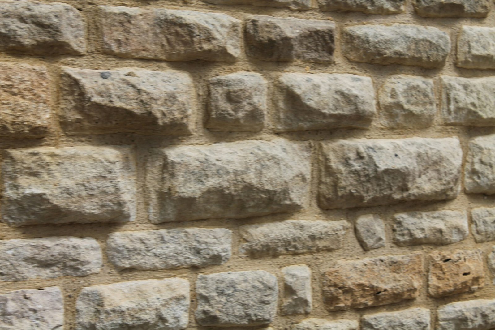 a close up of a brick wall with a clock on it