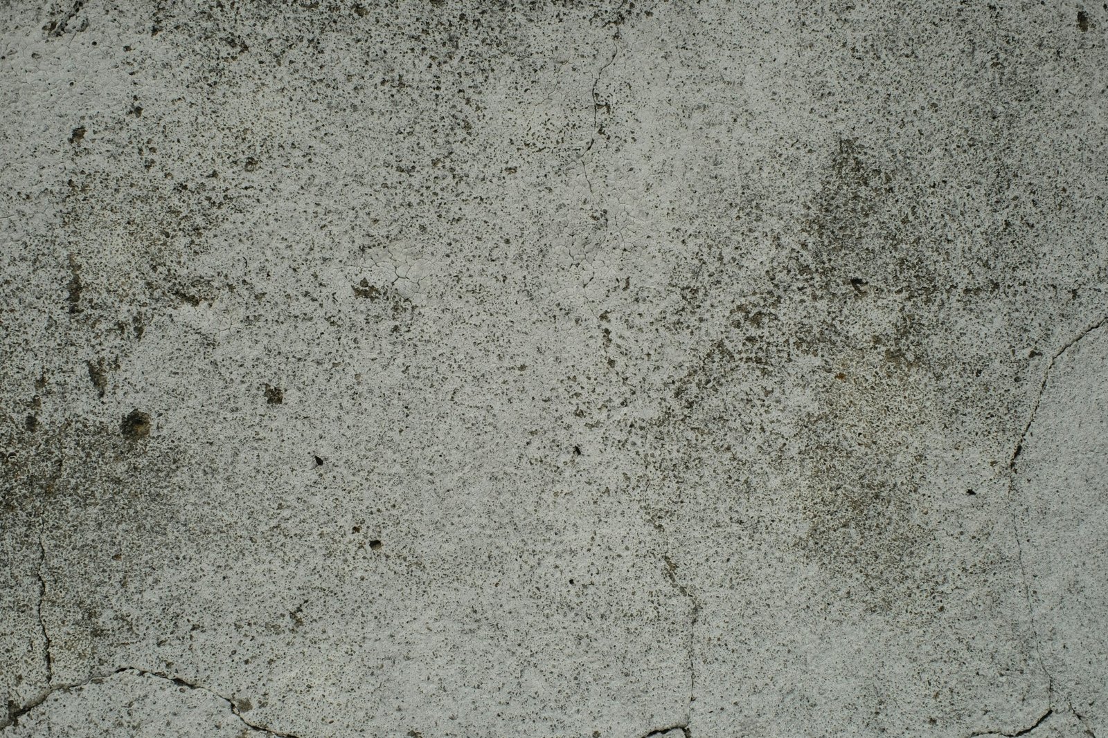 A close up of a cement surface with small cracks