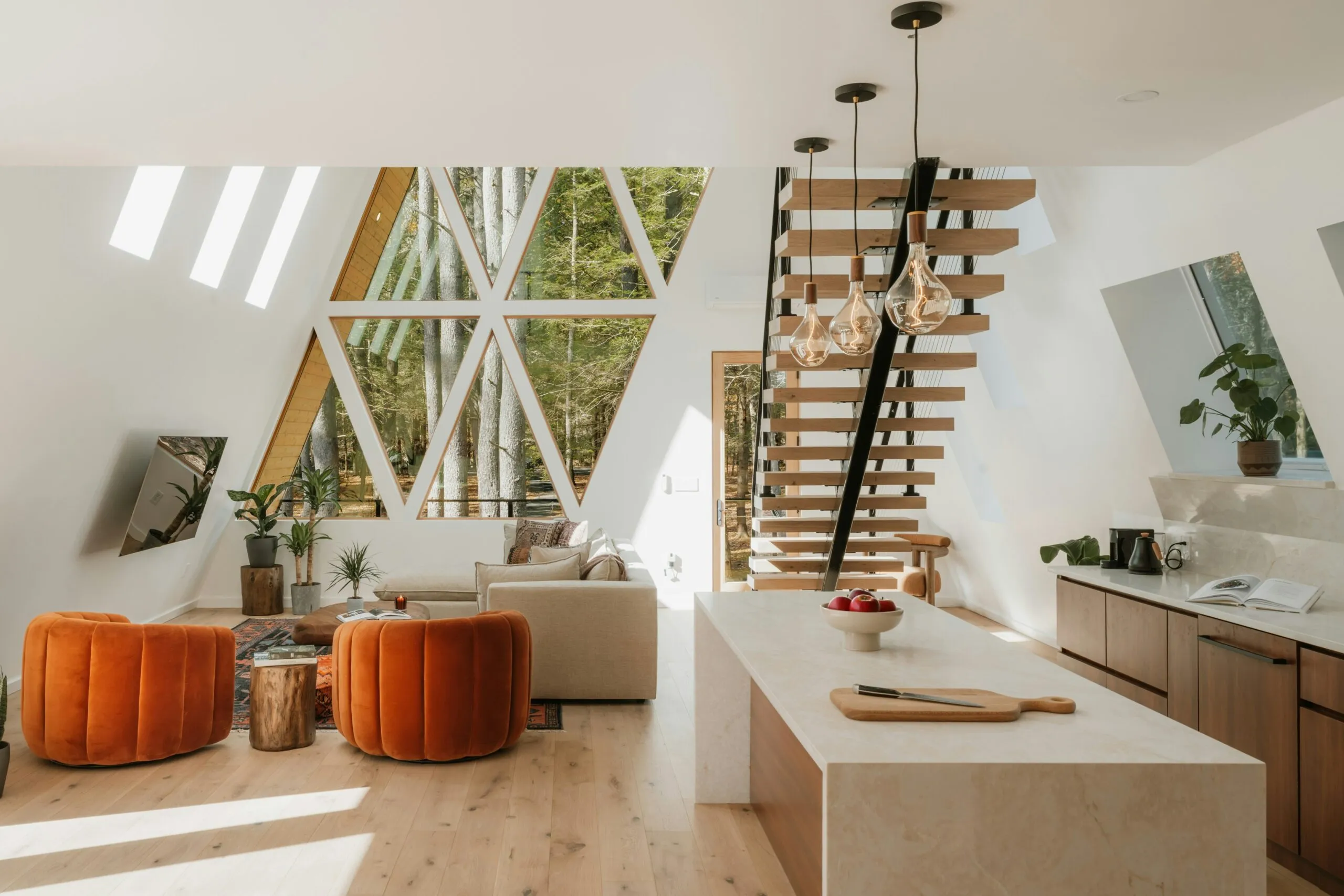Modern a-frame interior with living area and kitchen.