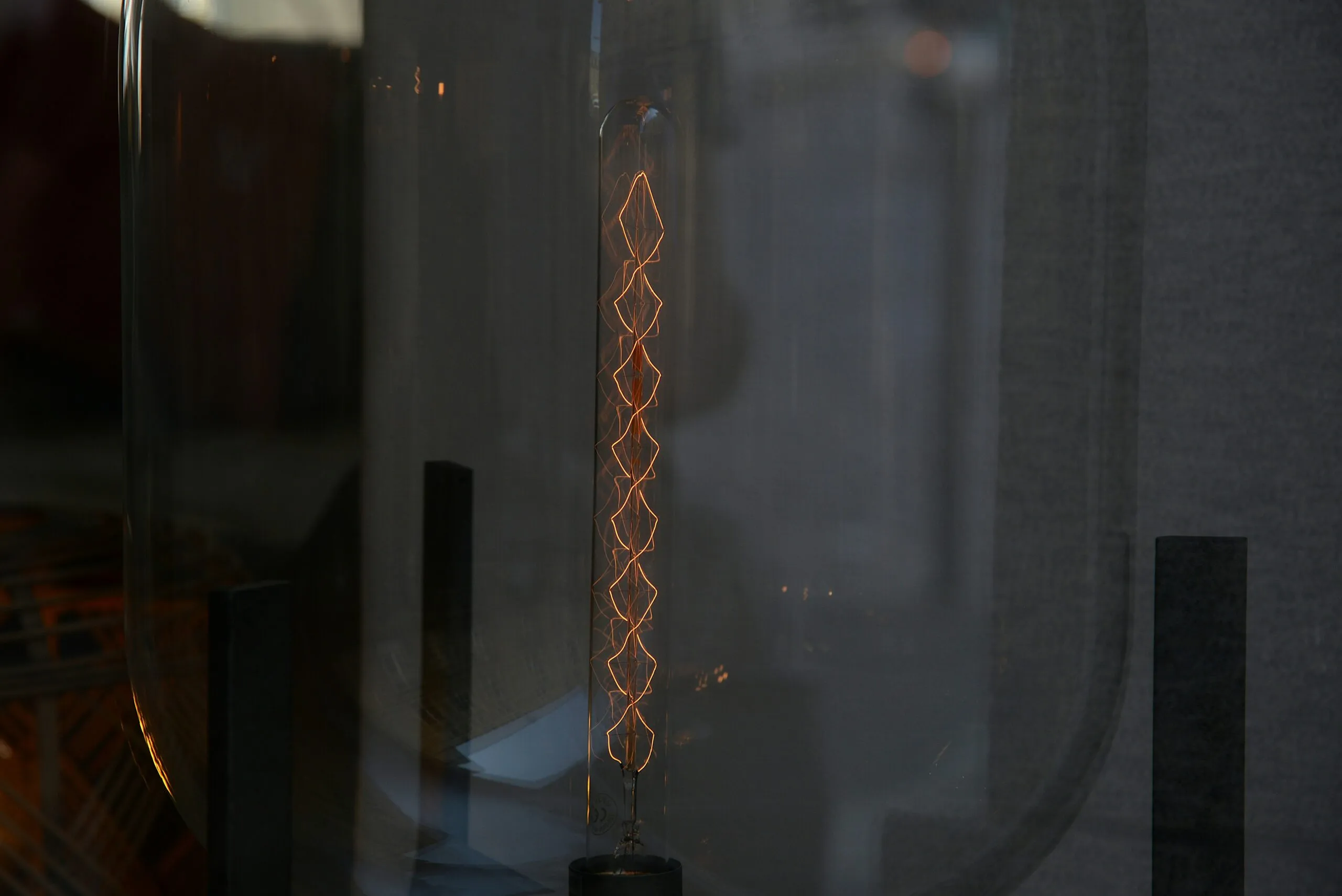 a close up of a glass door with a light in it