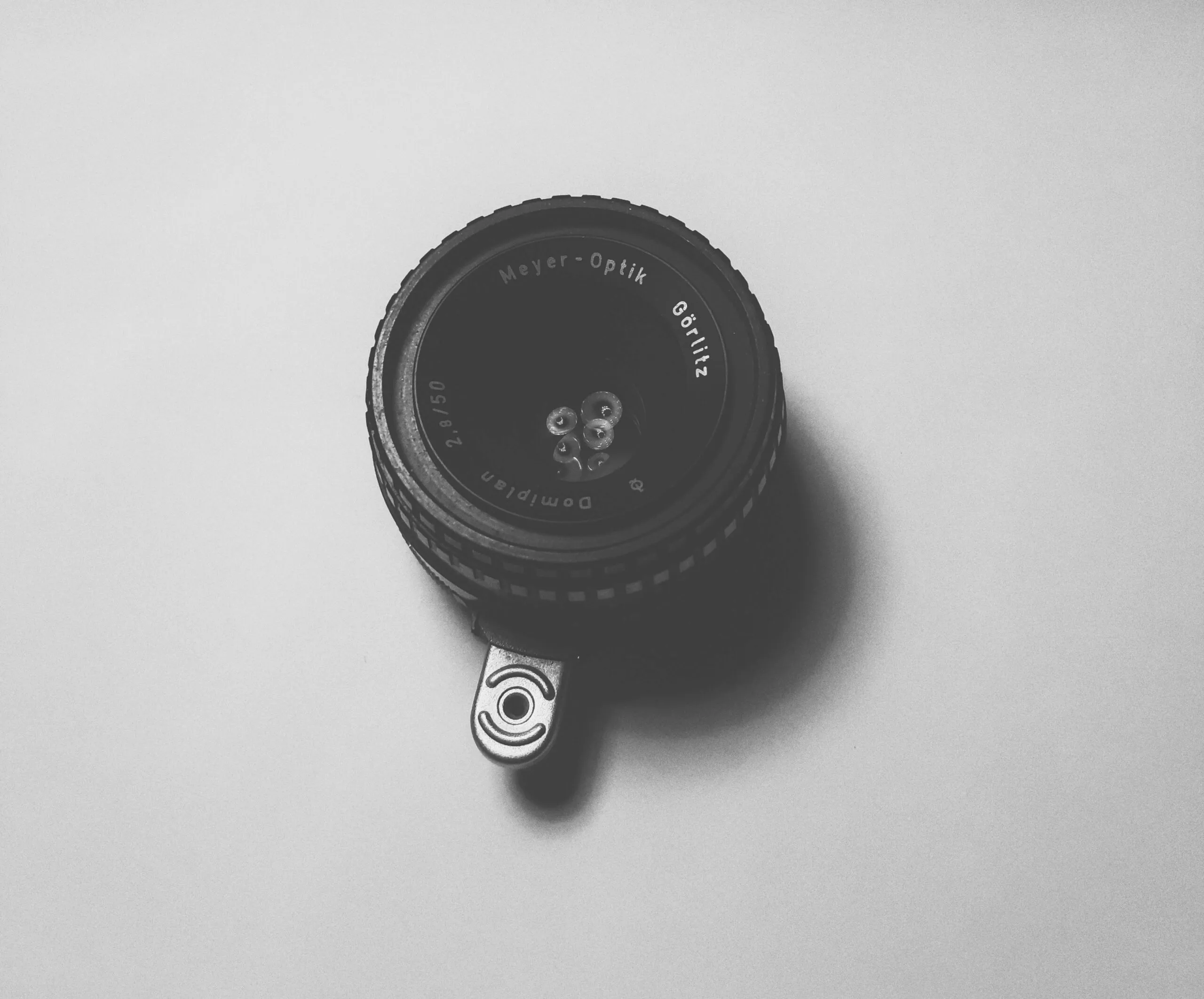 A black camera lens with a silver attachment.
