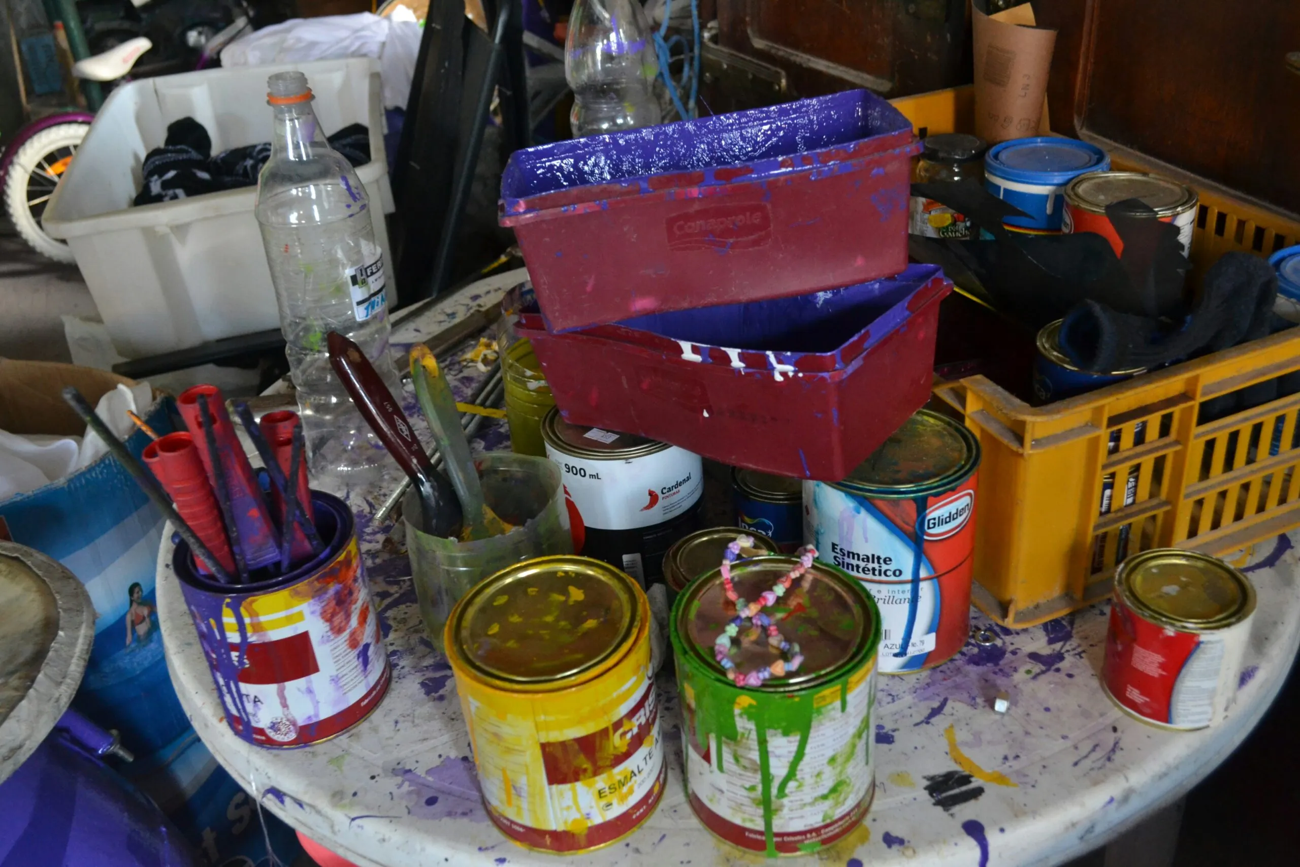 a table topped with lots of paint cans