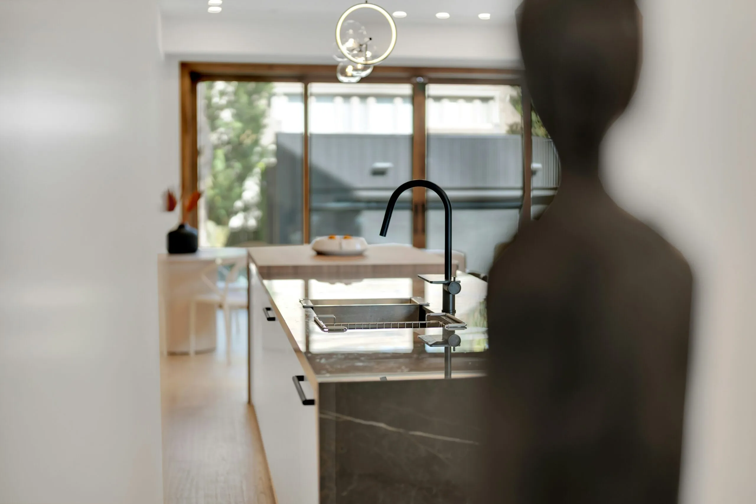 Modern kitchen island with sink and faucet.