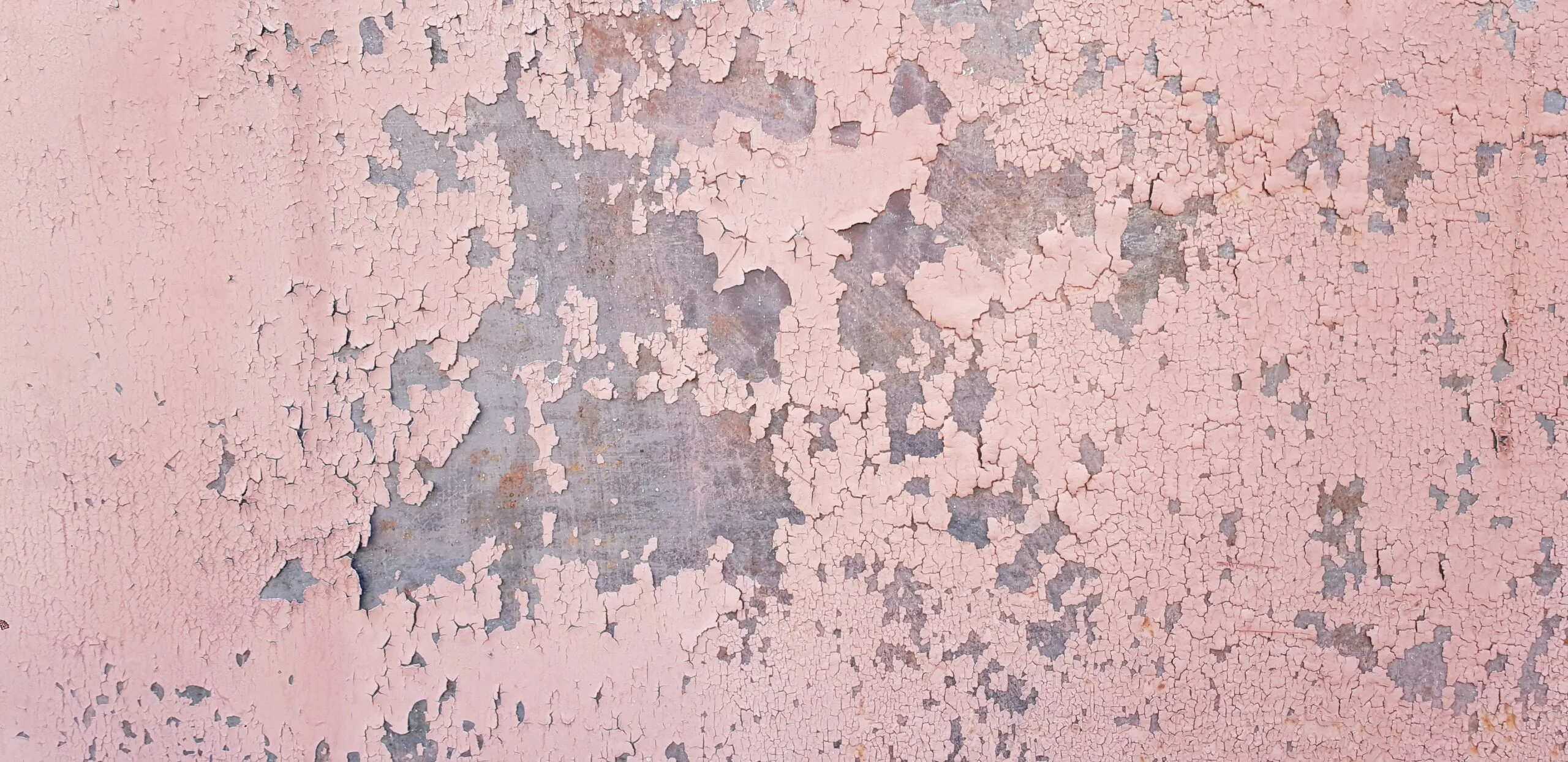 a close up of a wall with peeling paint