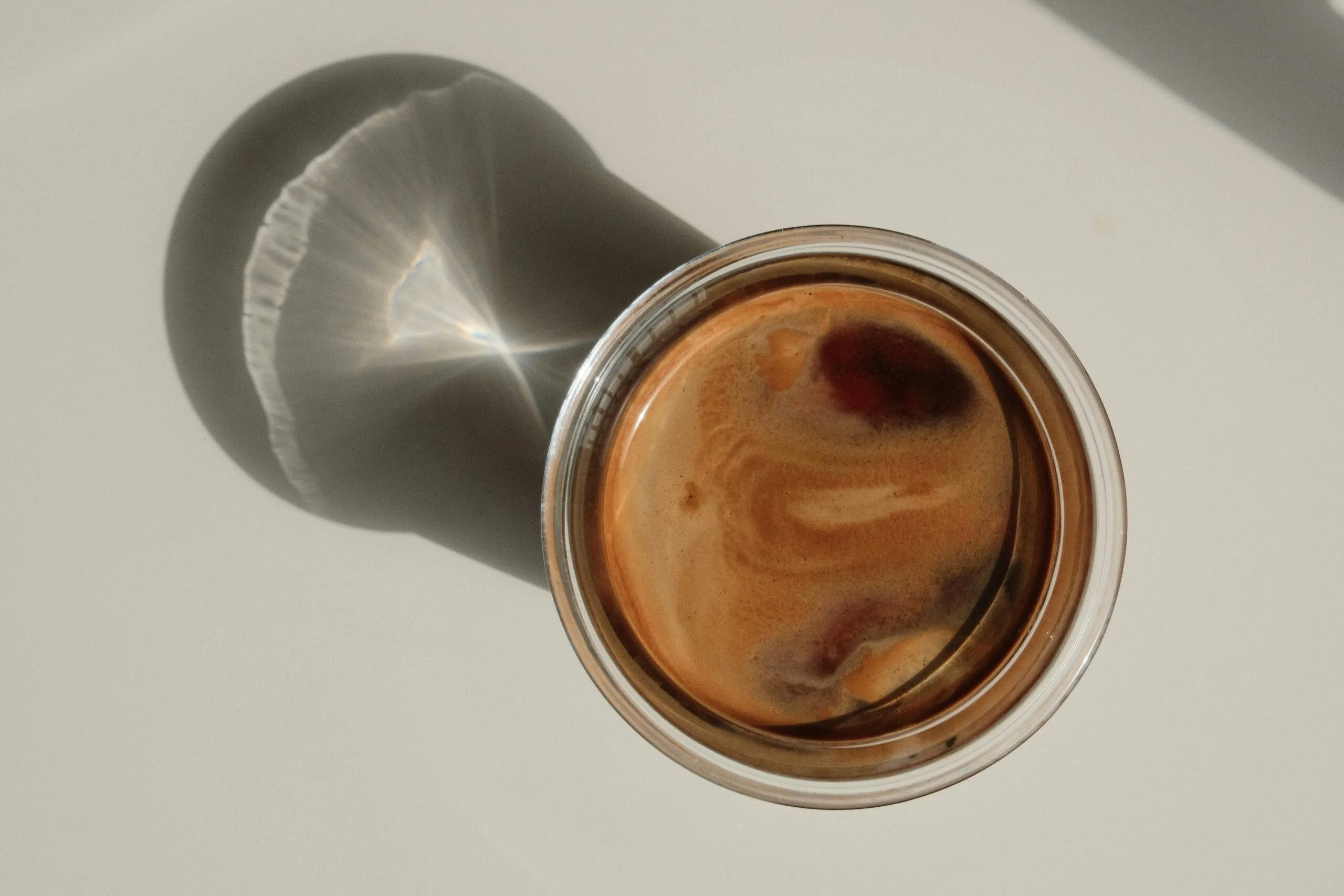 a cup of coffee sitting on top of a table