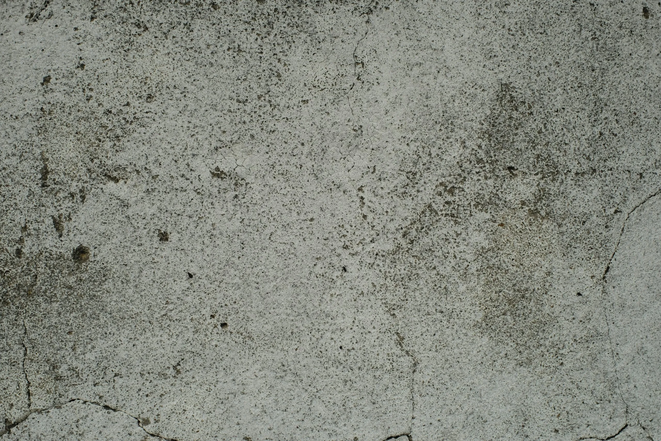 A close up of a cement surface with small cracks
