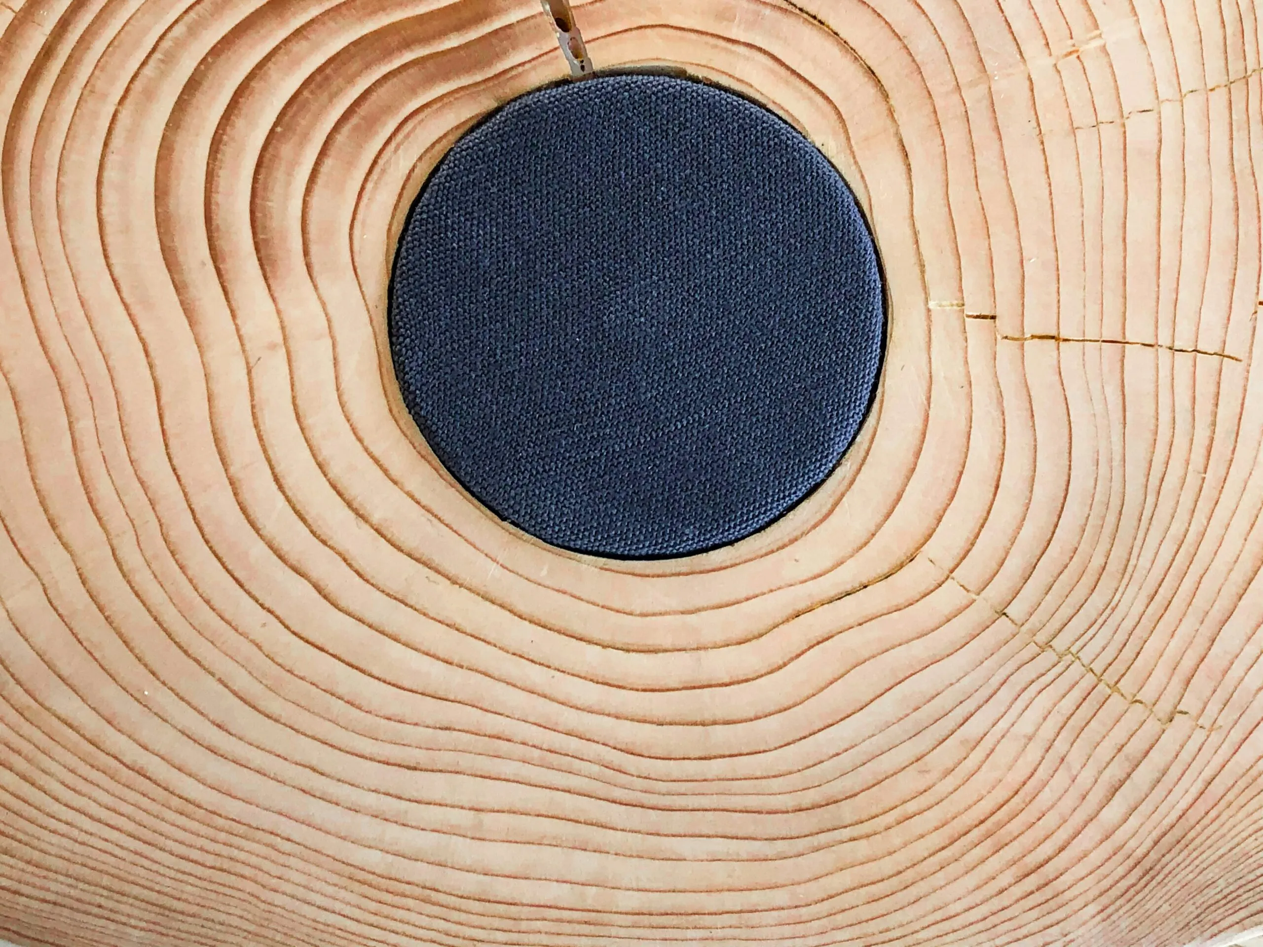 black round pendant necklace on white textile