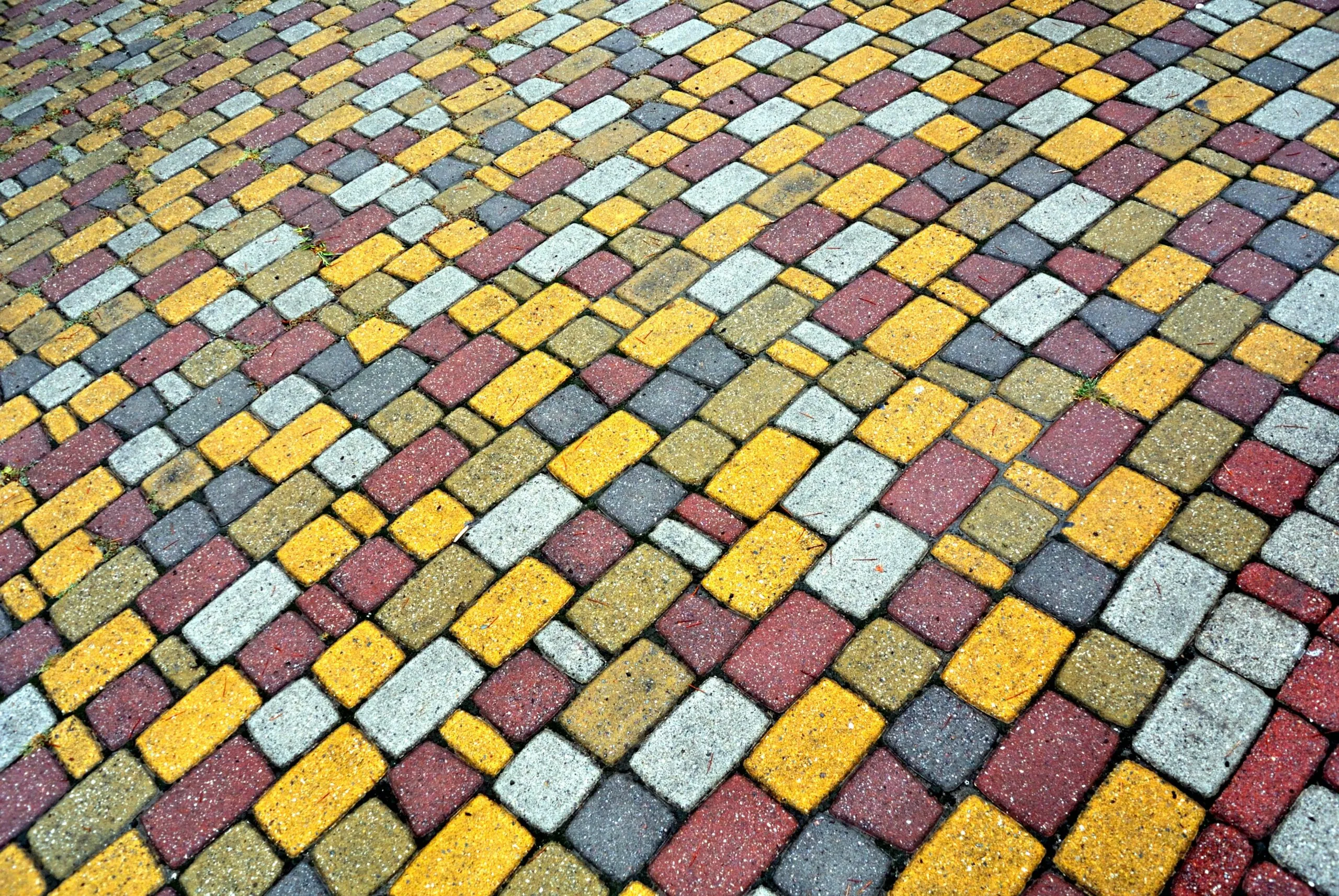 a cobblestone road with a pattern of bricks