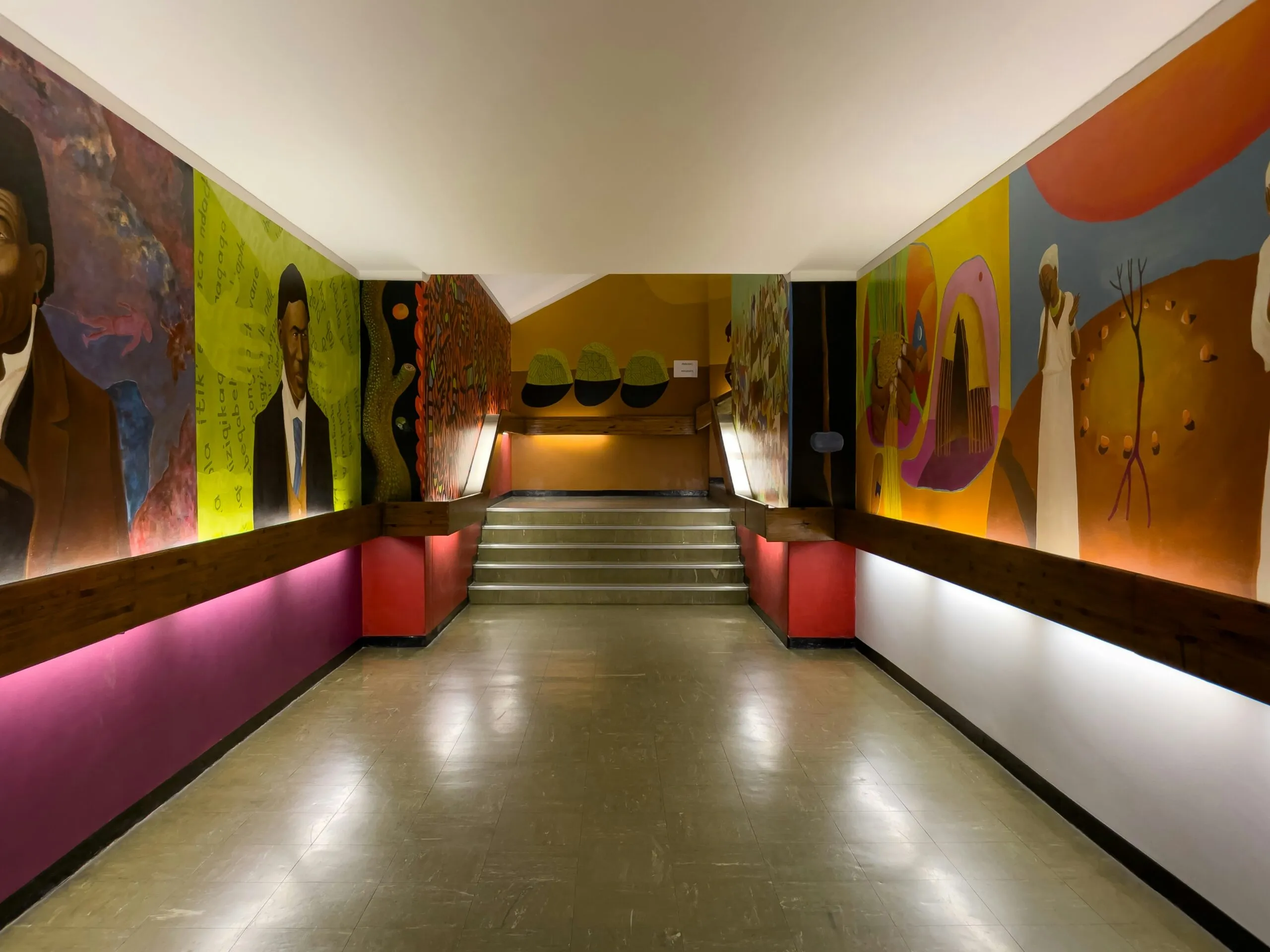 A long hallway with paintings on the walls