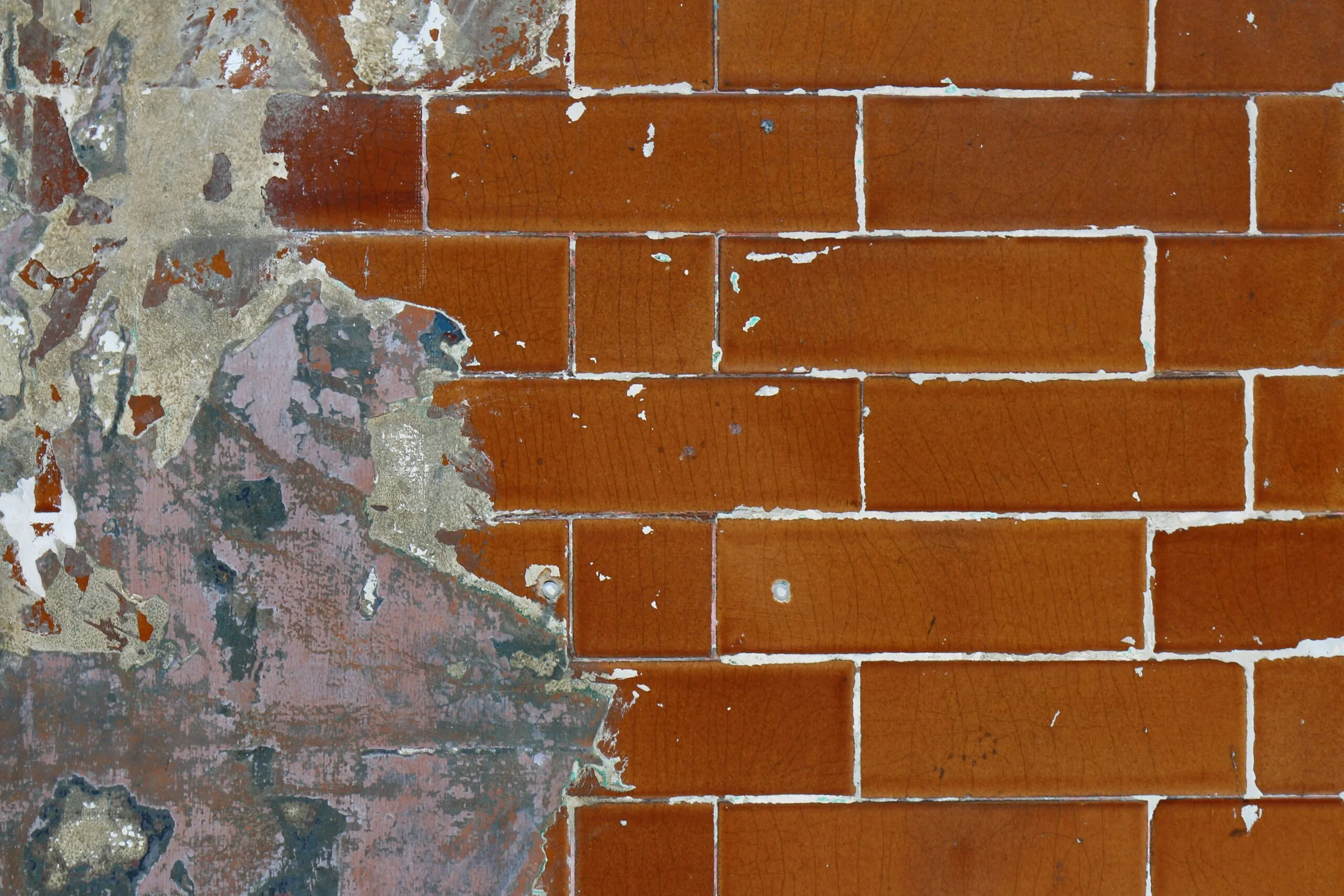 brown brick wall with gray and brown paint