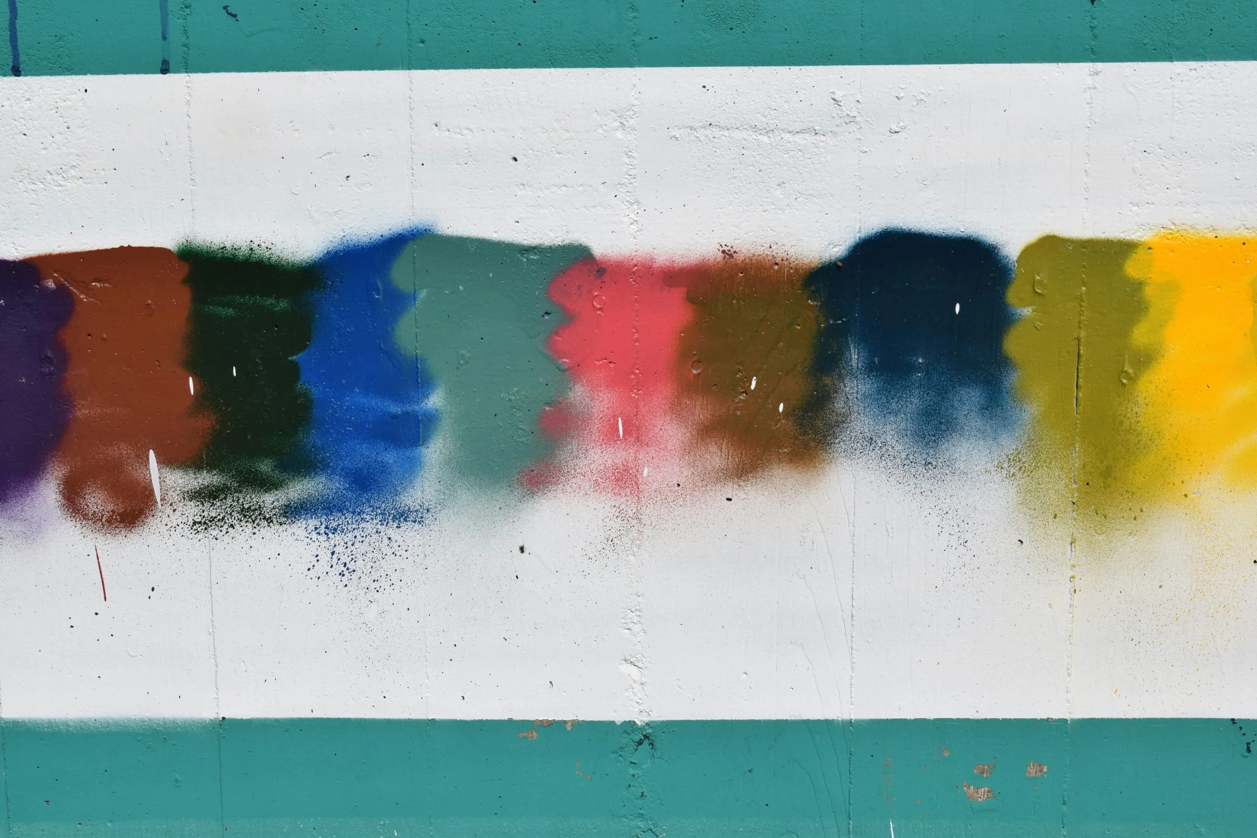 a group of different colors of paint on a wall