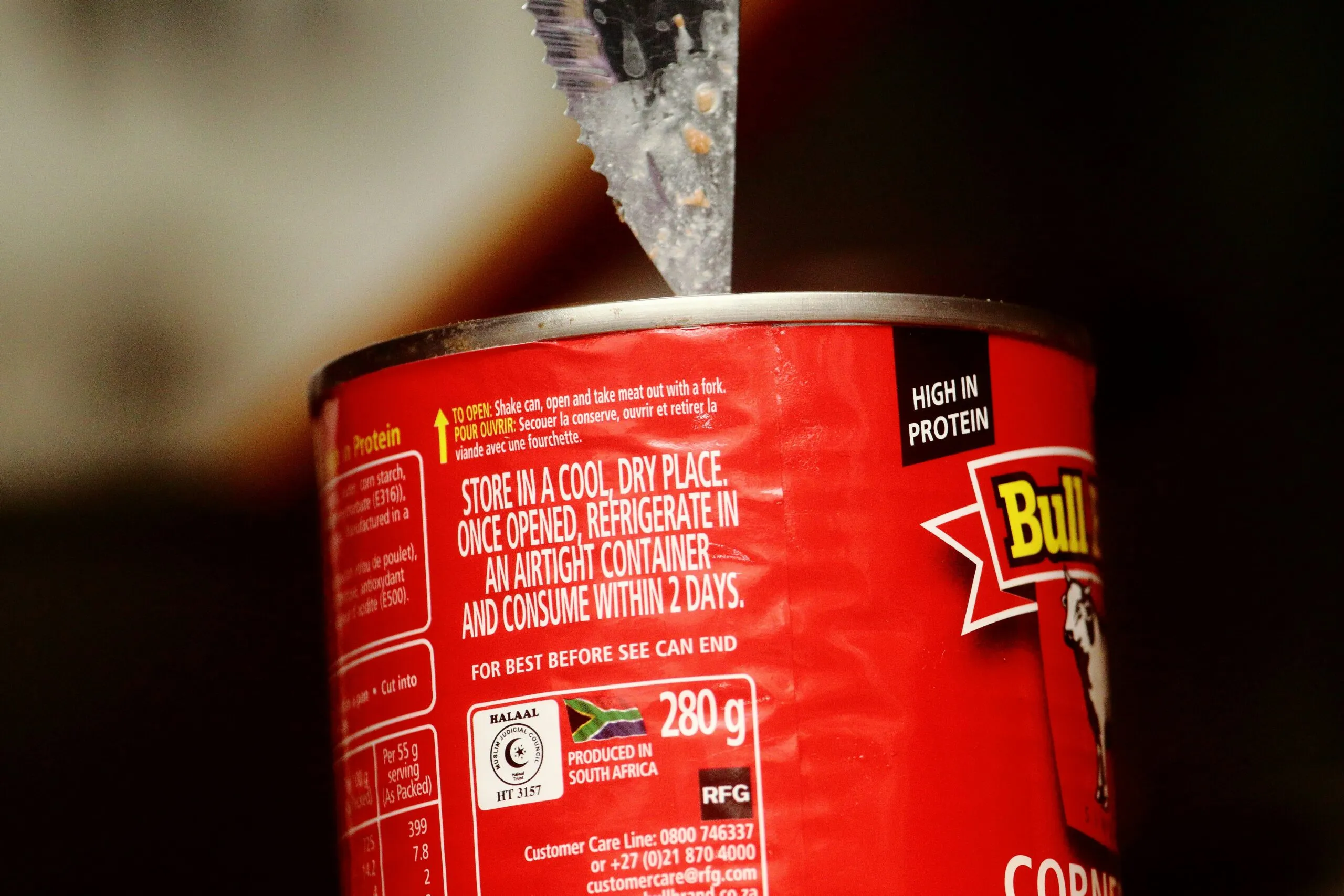 a close up of a can of food with a toothbrush sticking out of it
